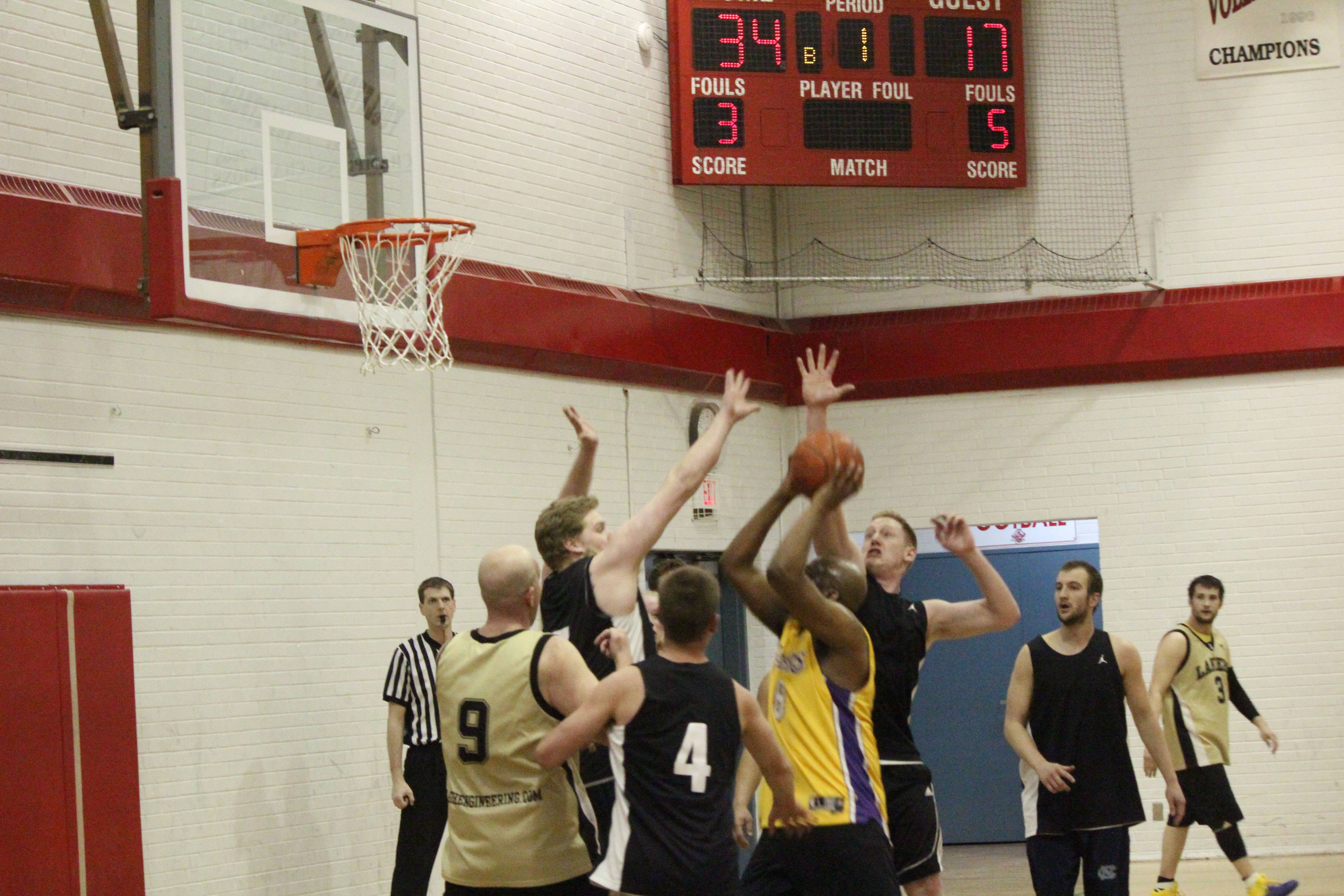 SURE SHOT- The Monstars (in black) face off against the Tagish Lakers (in gold) in the quarter finals at LTCHS on Thursday night.