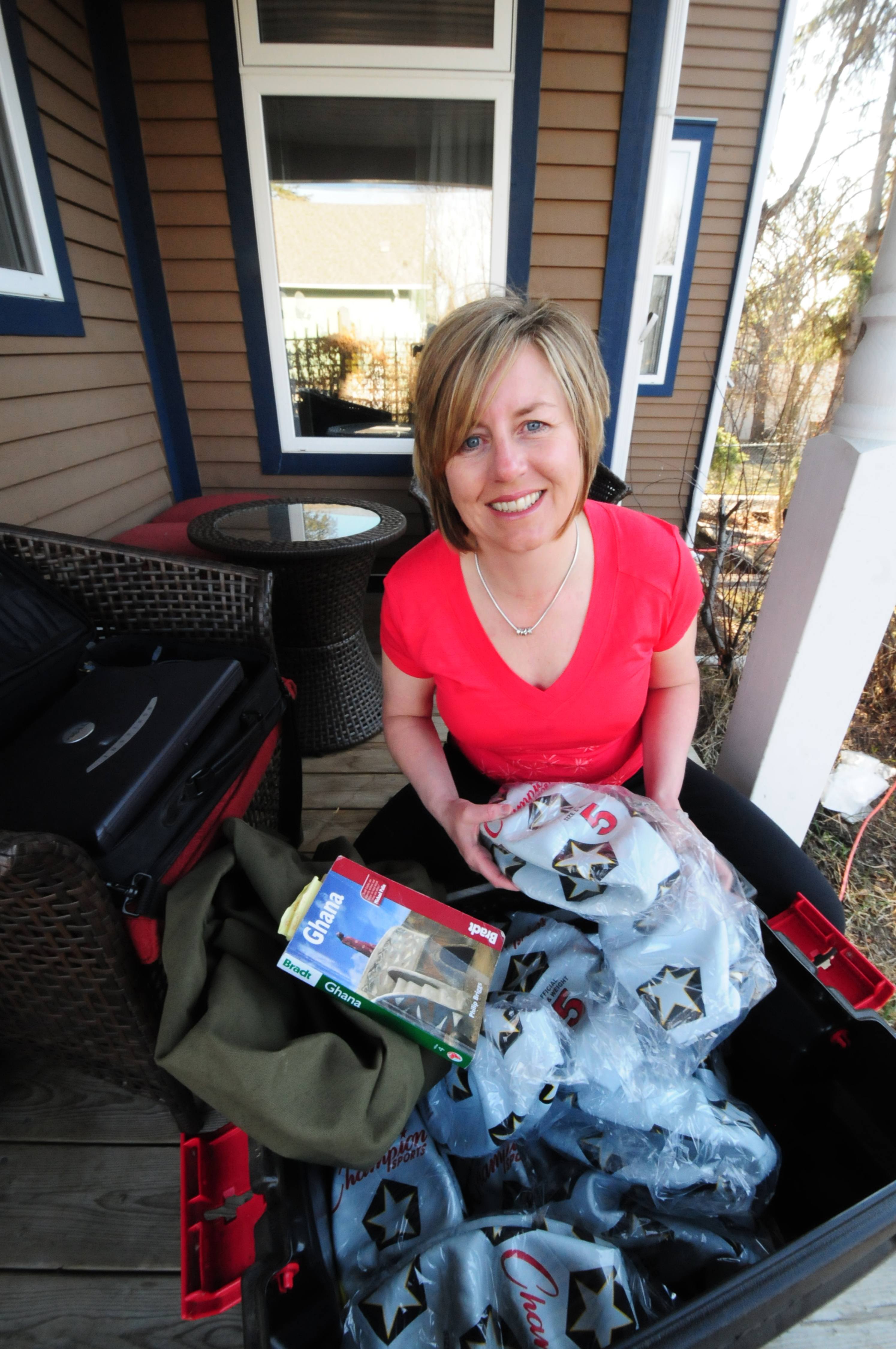 PREPARING-  City councillor Cindy Jefferies shows some of the soccer balls donated for children in Ghana