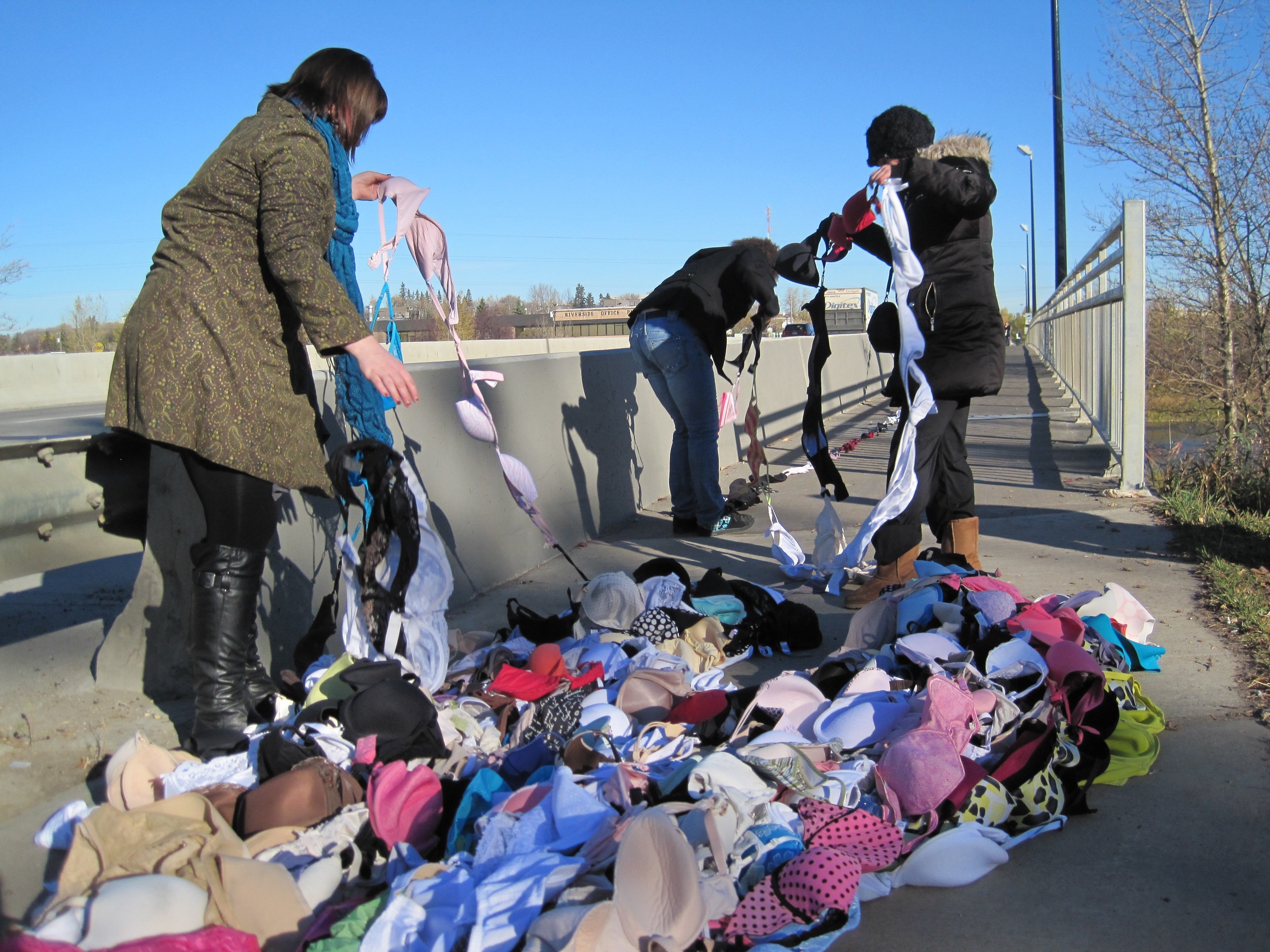 BRAS OVER RIVER – Staff at The RIVER radio station stretch more than 700 bras across the Red Deer River at the Gaetz Ave. North Bridge Thursday morning to raise awareness of breast cancer. October is Breast Cancer Awareness Month in Canada.
