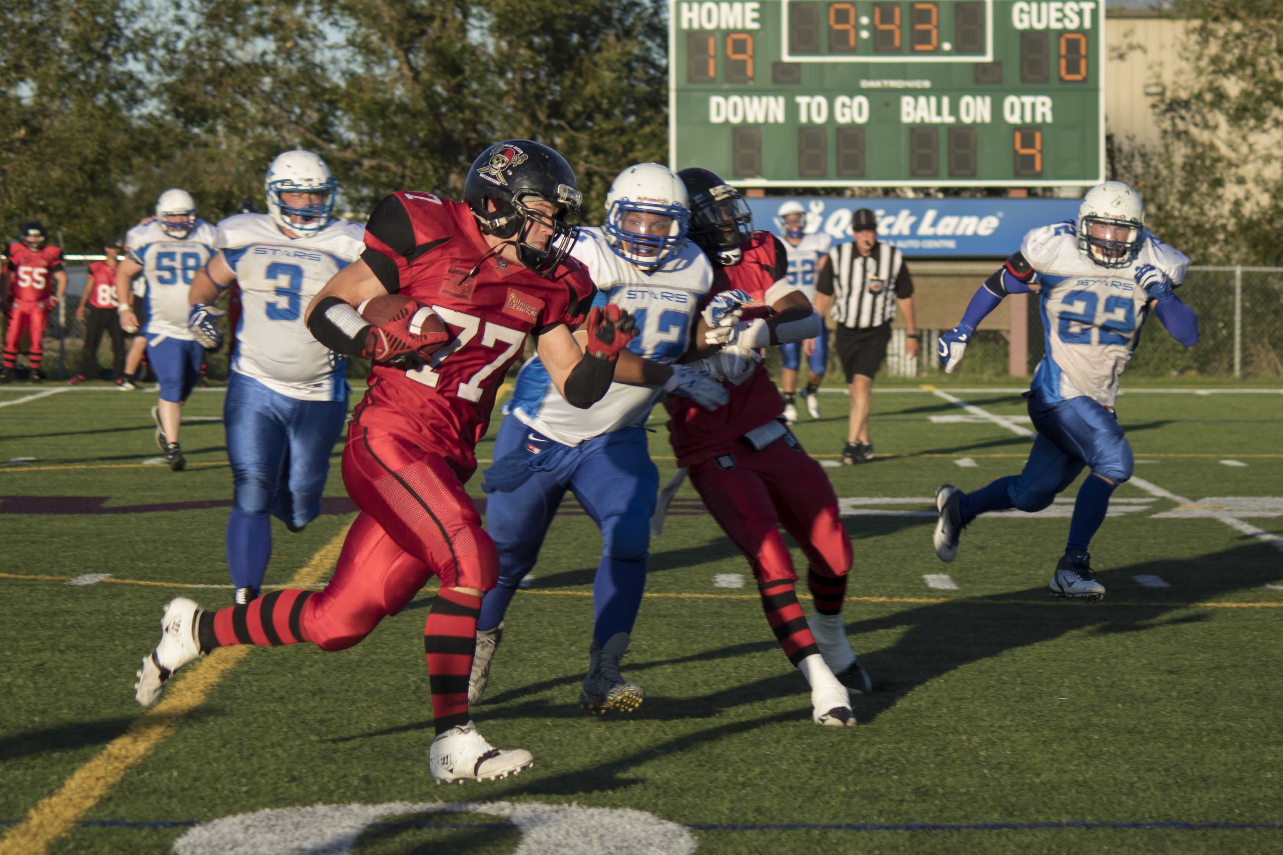 ON THE MOVE – Central Alberta Buccaneer Ian Keetch focused and successfully evaded several members of the St. Albert Stars team during a recent match-up at Me Global Athletic Park. The Bucs hosted the Stars for their last home game of the regular season and came out with a score of 19-6.