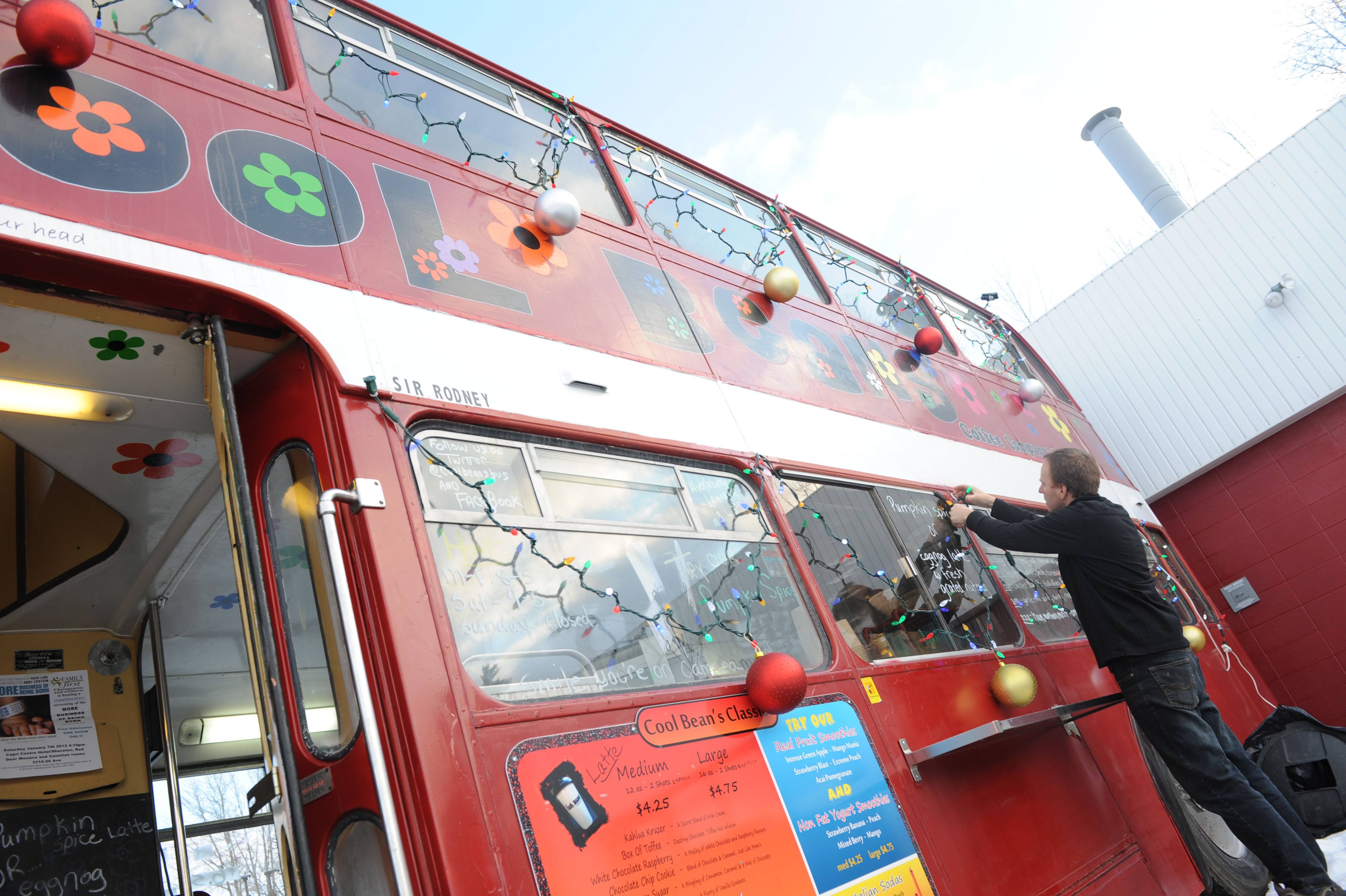 BIG CANVAS- Kevin Traptow with Cool Beans decorates the double-decker bus where the coffee shop is located.