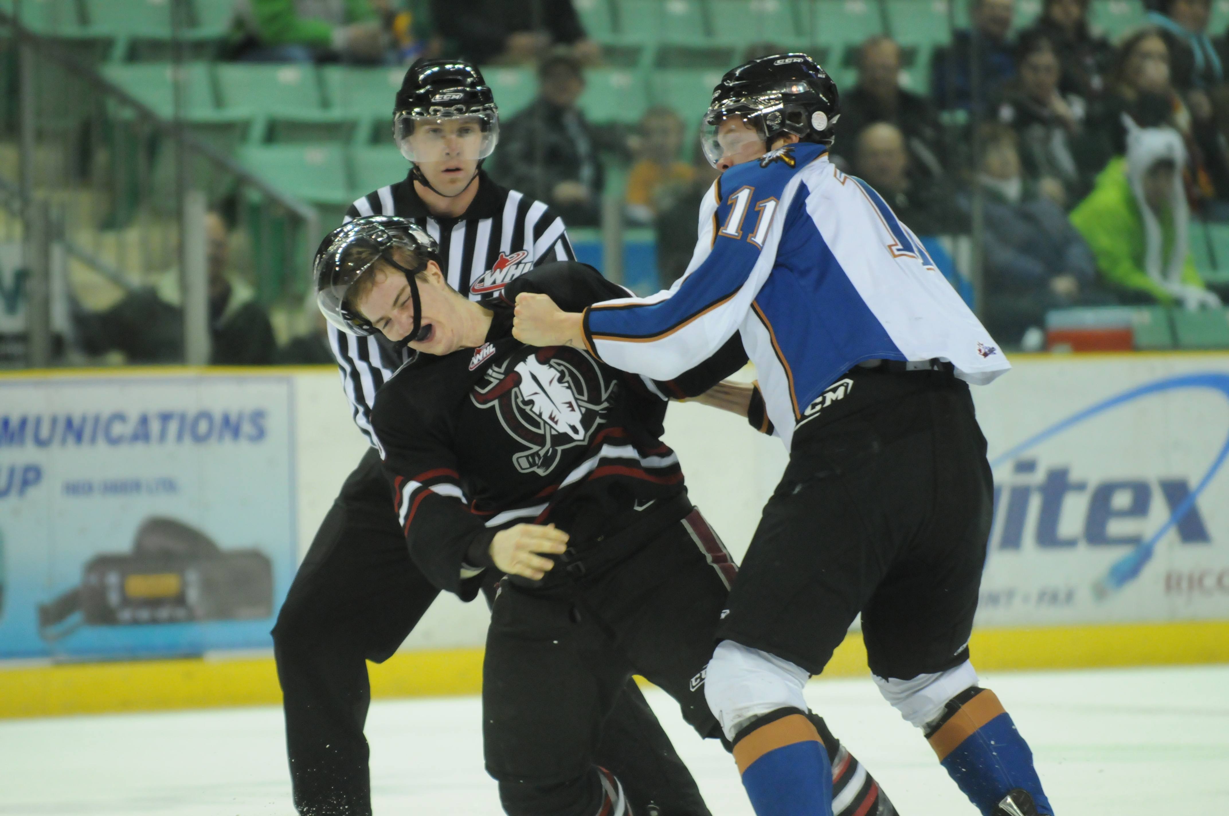 FLYING FISTS- Red Deer Rebel Brett Ferguson fights with Matt Fraser of the Kootenay Ice Tuesday night during WHL action in Red Deer. The Rebels won 5-0.
