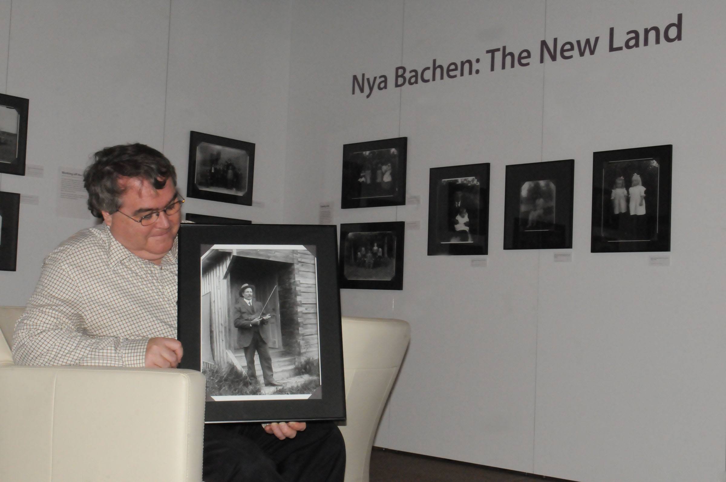 LEGACY-Local historian Michael Dawe takes a closer look at one of the portraits being featured in Nya Bachen: The New Land. The photo exhibit is showing at the Red Deer Museum + Art Gallery through to Jan. 9.