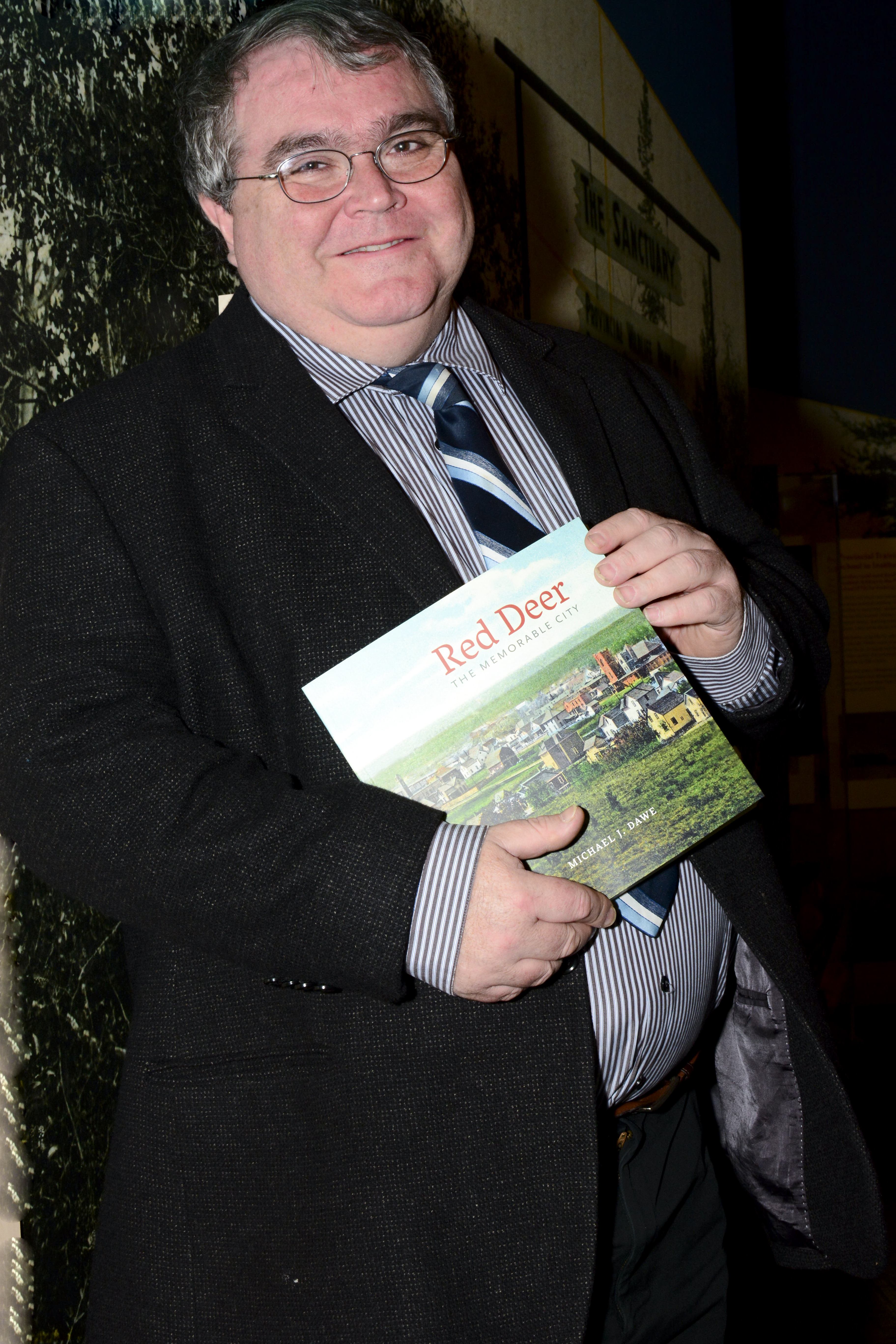 COMMEMORATION - Local historian Michael Dawe shows off the book he wrote