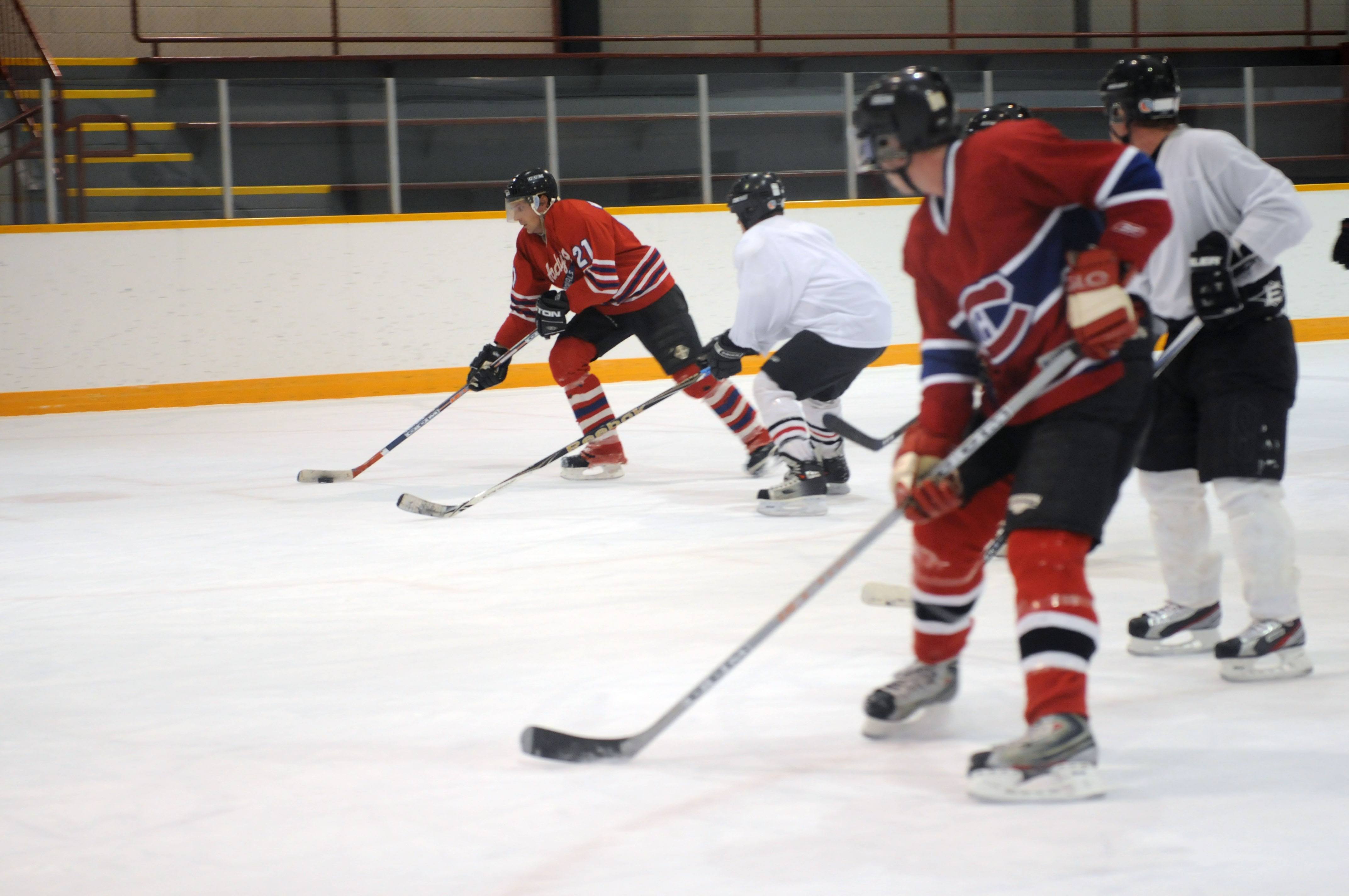 TOUGH BUNCH- Jeff Kuytnec takes the puck down the ice at the Dawe Centre recently during a drop-in hockey game.