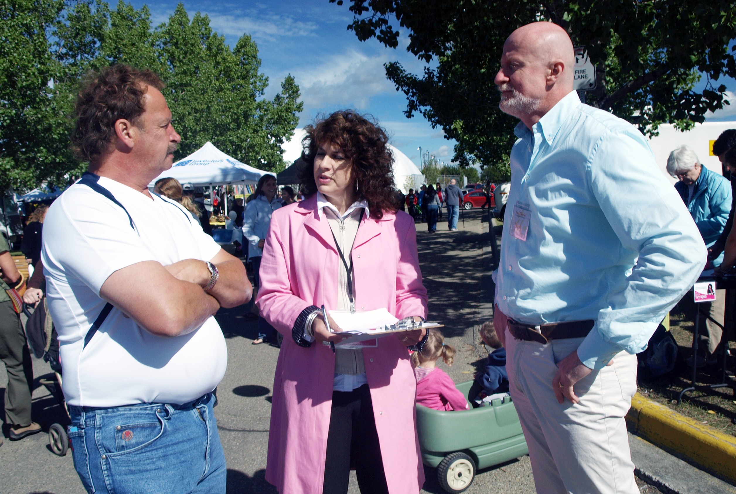 LISTENING - Dianne Wyntjes and Paul Harris (right) speak with locals Saturday at the Market at Red Deer where they were campaigning for council.