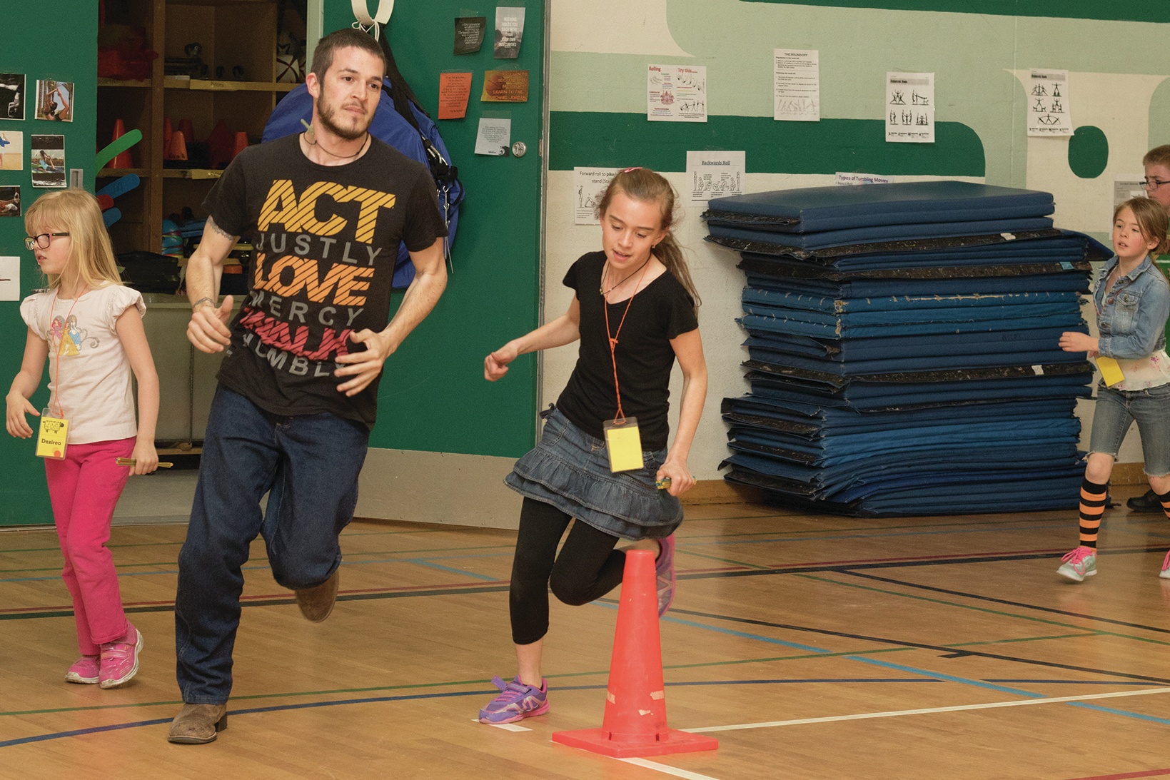 WORKING TOGETHER - Hope Mission staff member Phill Hollis ran alongside 10-year-old Vita Fesik during a Kids in Action event at Normadeau School. Part of the program works to encourage physical activity in kids and promotes a 5k run where each young student runs alongside an older student to help both parties finish their committment and remain active.