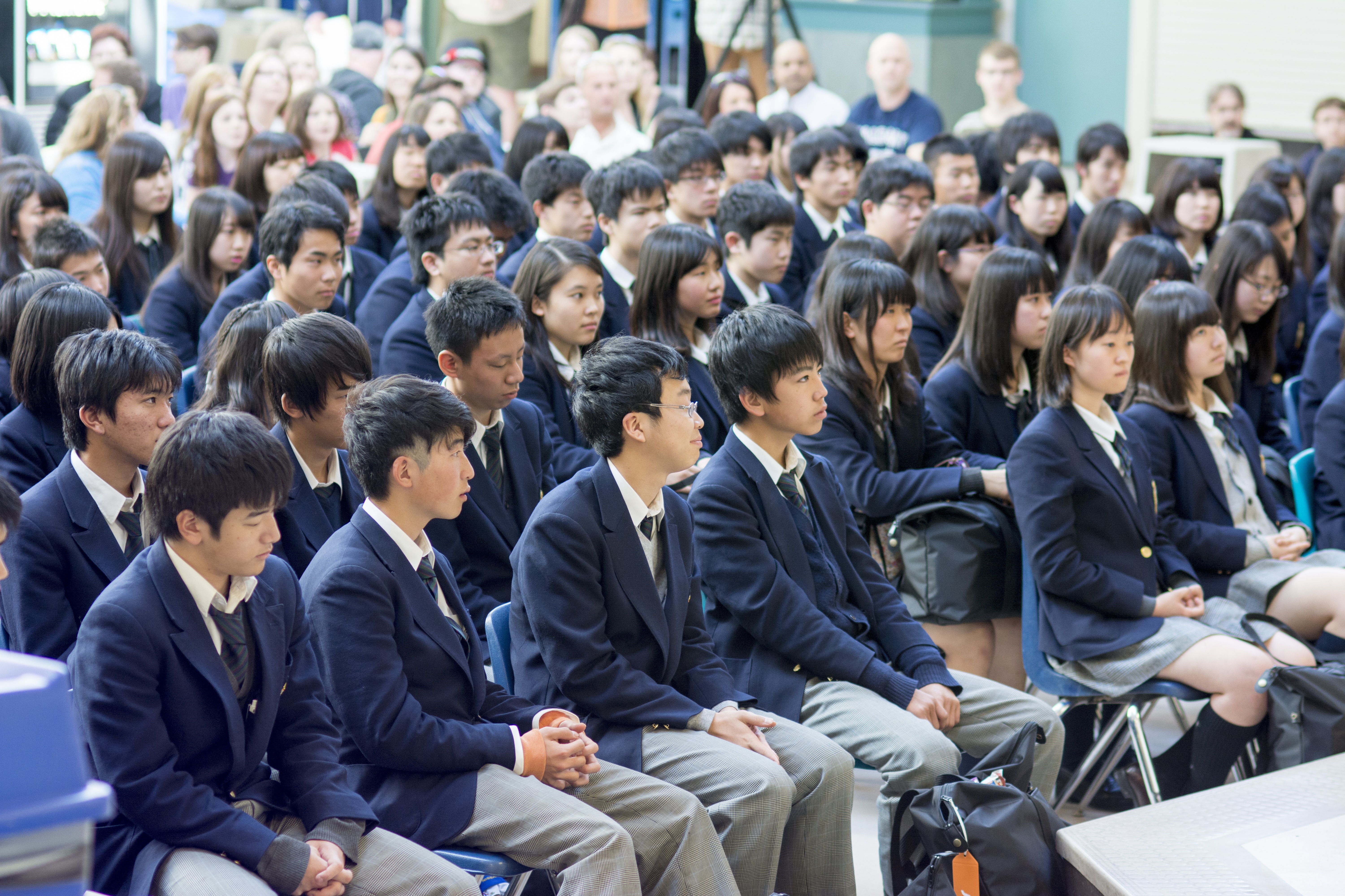 CELEBRATED WELCOME – Japanese students listen on as representatives from Ecole Notre Dame Secondaire welcome them after arriving at the local high school last Friday. The 115 students are part of a two-week exchange partnership between Central Alberta and Yamate High School in Japan.