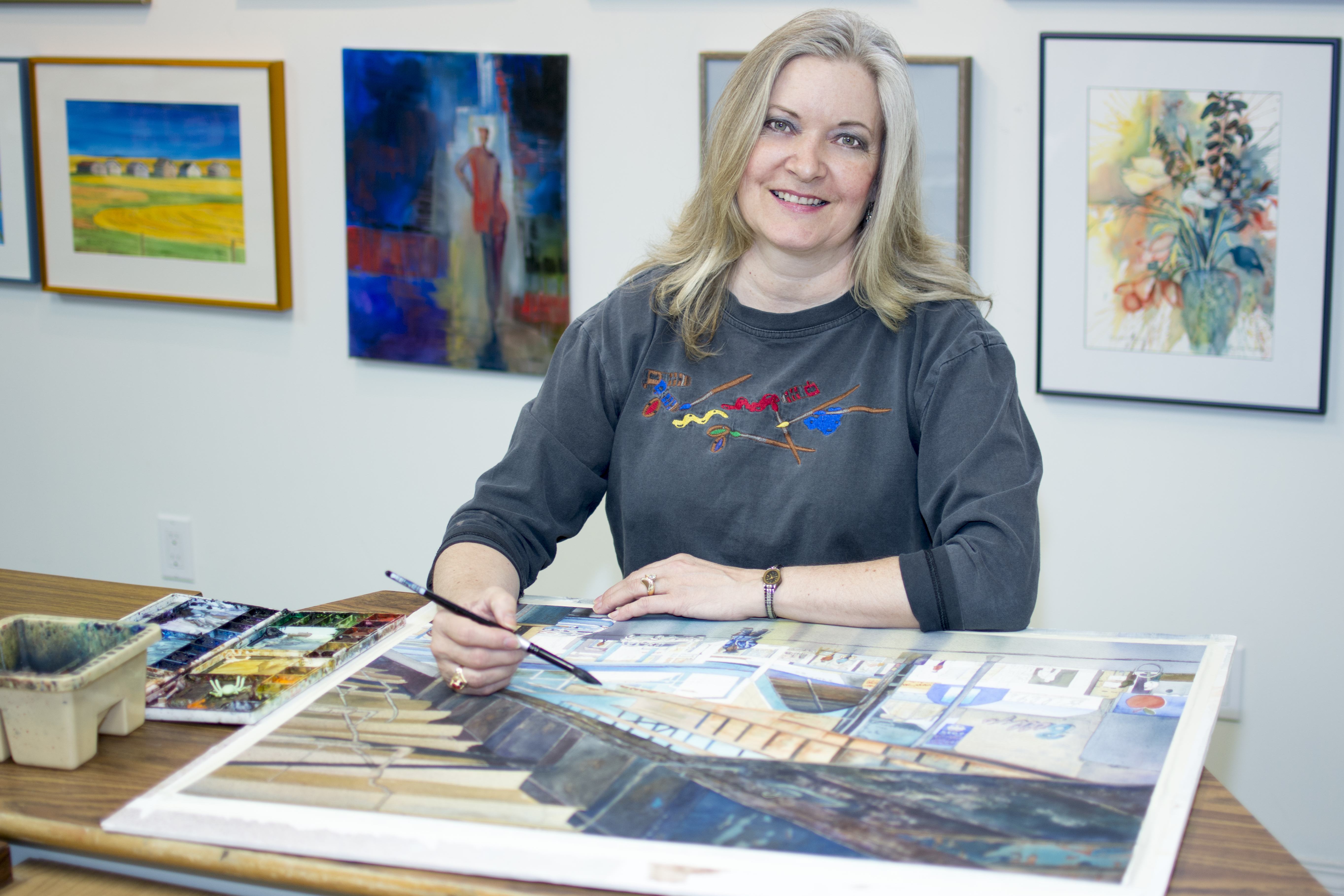 EXPRESSION – Red Deer artist Marianne Harris shows how it’s done in her basement studio recently. She’s gearing up for an open house this weekend.