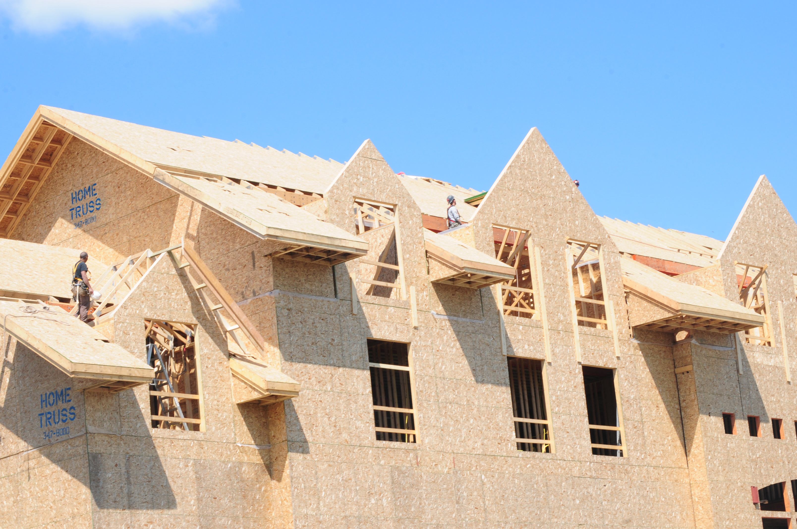 STEADY WORK- Tradesmen work on the roof of the Ronald McDonald House as construction continues to move along.