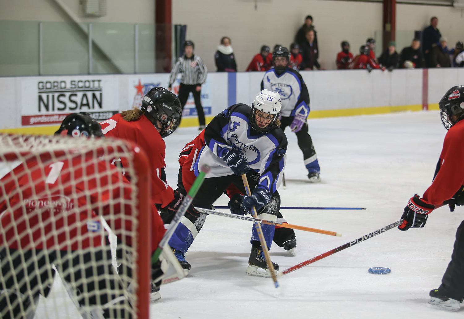 QUICK MOVES - Alexa Swenson of the U14A Red Deer Riot tried to get past members of the Strathmore Fire & Ice during round robin play at the 33rd Annual Red Deer Friends on Ice Tournament at the Kinsmen Community Arenas last weekend.