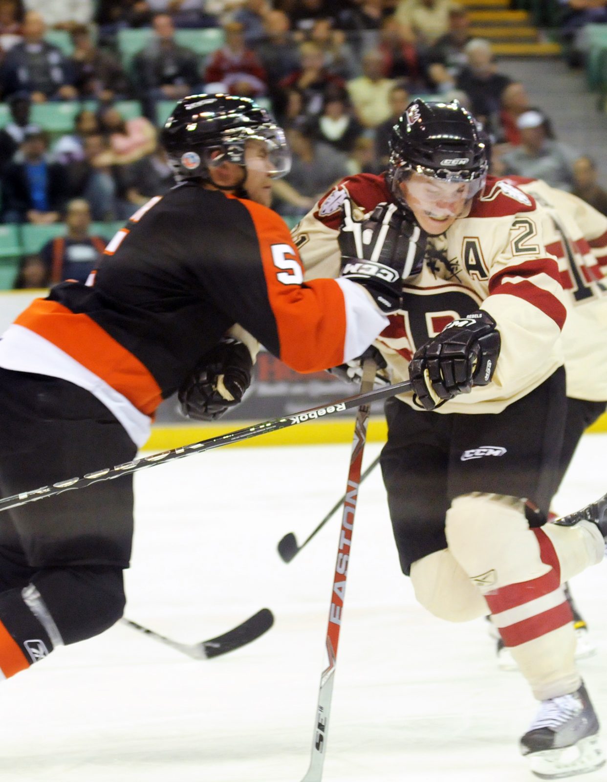 DOUBLE LOSS - Medicine Hat Tiger Thomas Carr pushes Red Deer Rebels Byron Froese back during WHL action Saturday night. The Rebels lost 4-1.