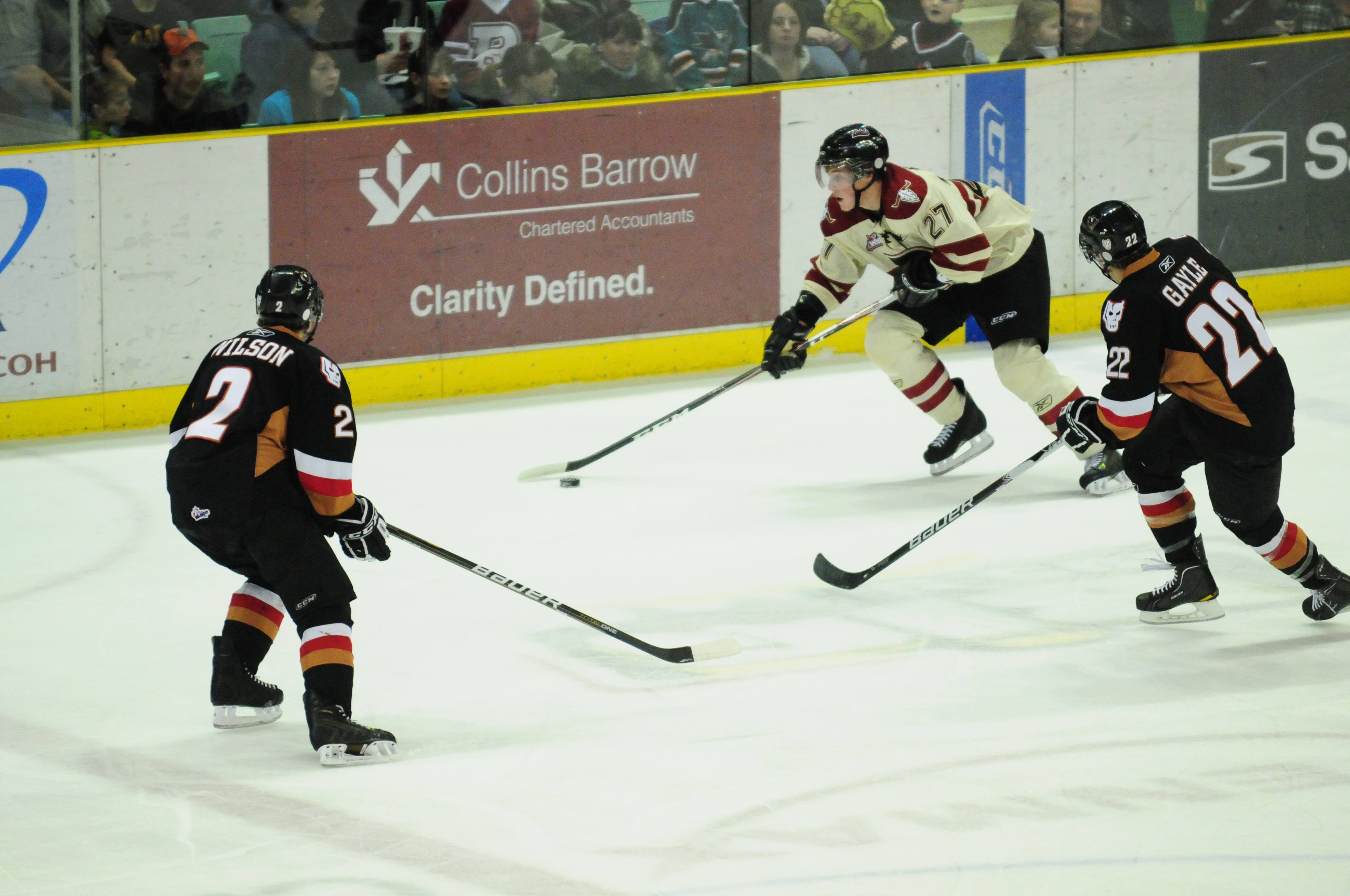 DODGING HITMEN- Red Deer Rebel Locke Muller looks to pass during WHL action Friday night against the Calgary Hitmen. The Rebels took down the Hitmen with a 4-1 win.