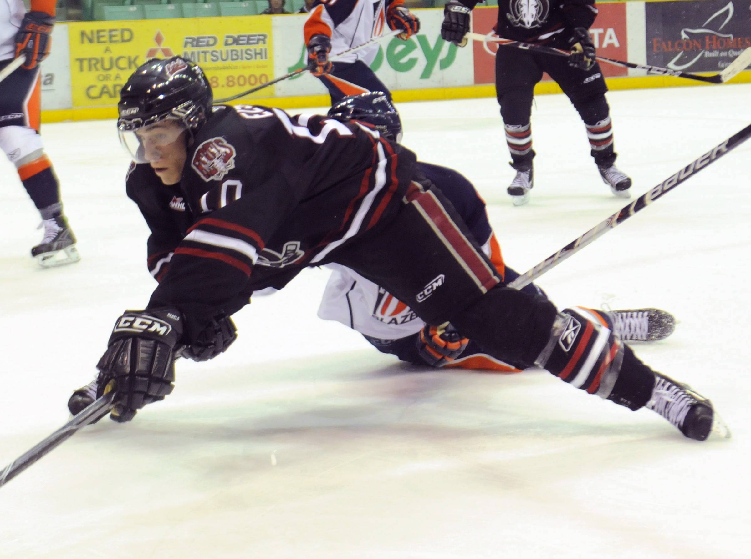 DIVE- Turner Elson of the Red Deer Rebels dives for the puck during WHL action Wednesday evening against Kamloops. The Rebels fought a tough battle but lost 1-0.
