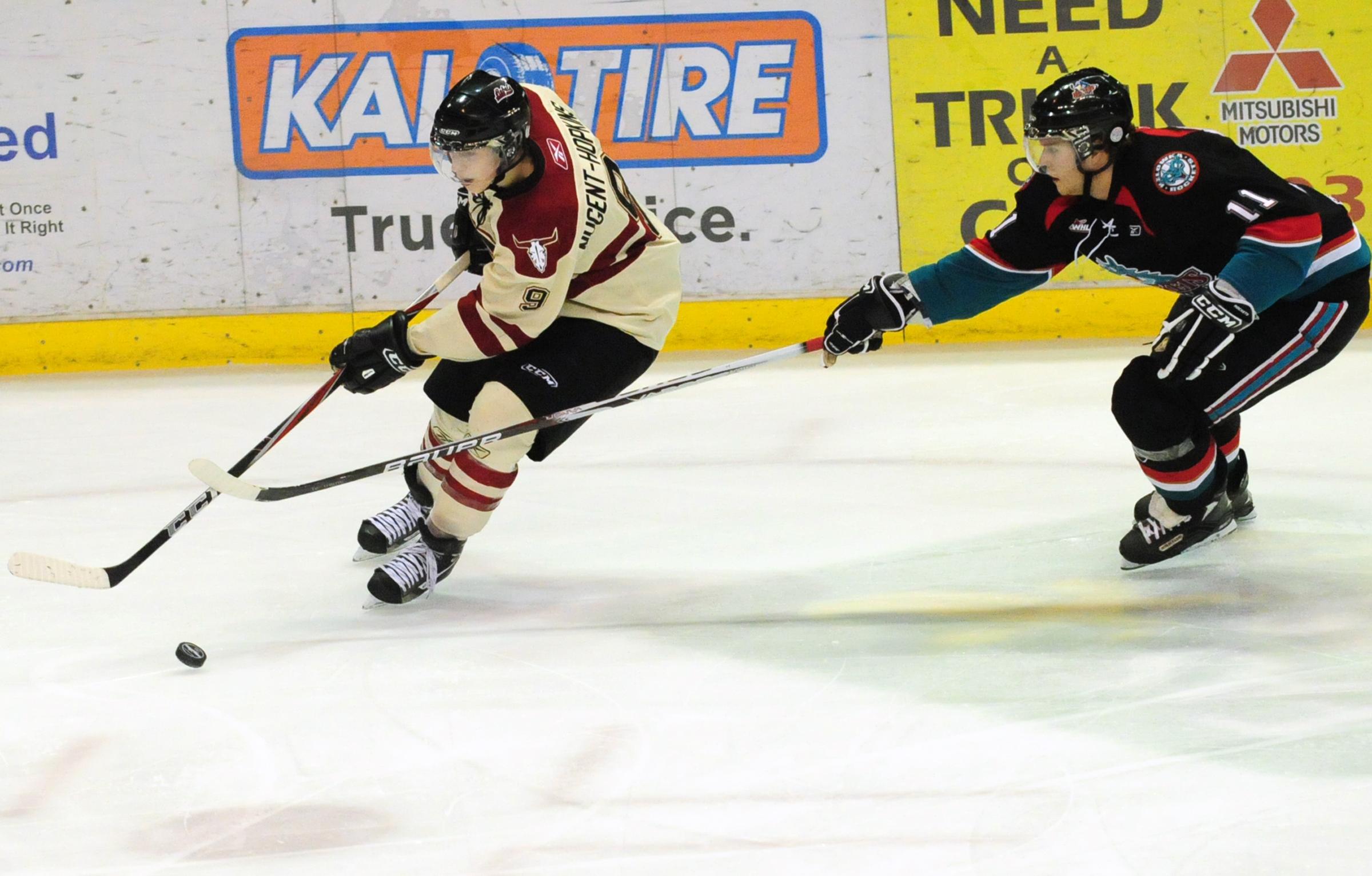 TOUGH LOSS- Red Deer Rebels Ryan Nugent-Hopkins steers the puck away from Geordie Wudrick during WHL action Friday night. The Rebels lost 0-1.