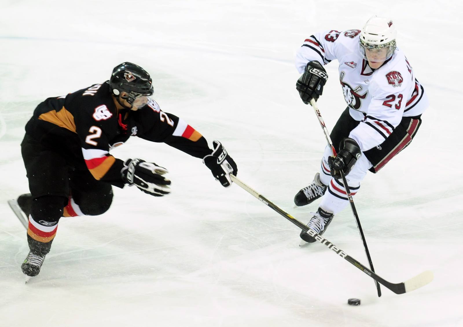 BIG WIN- Red Deer Rebel Adam Kambeitz steals the puck from Calgary Hitmen Ben Wilson during WHL action Friday night. The Rebels won 5-1.