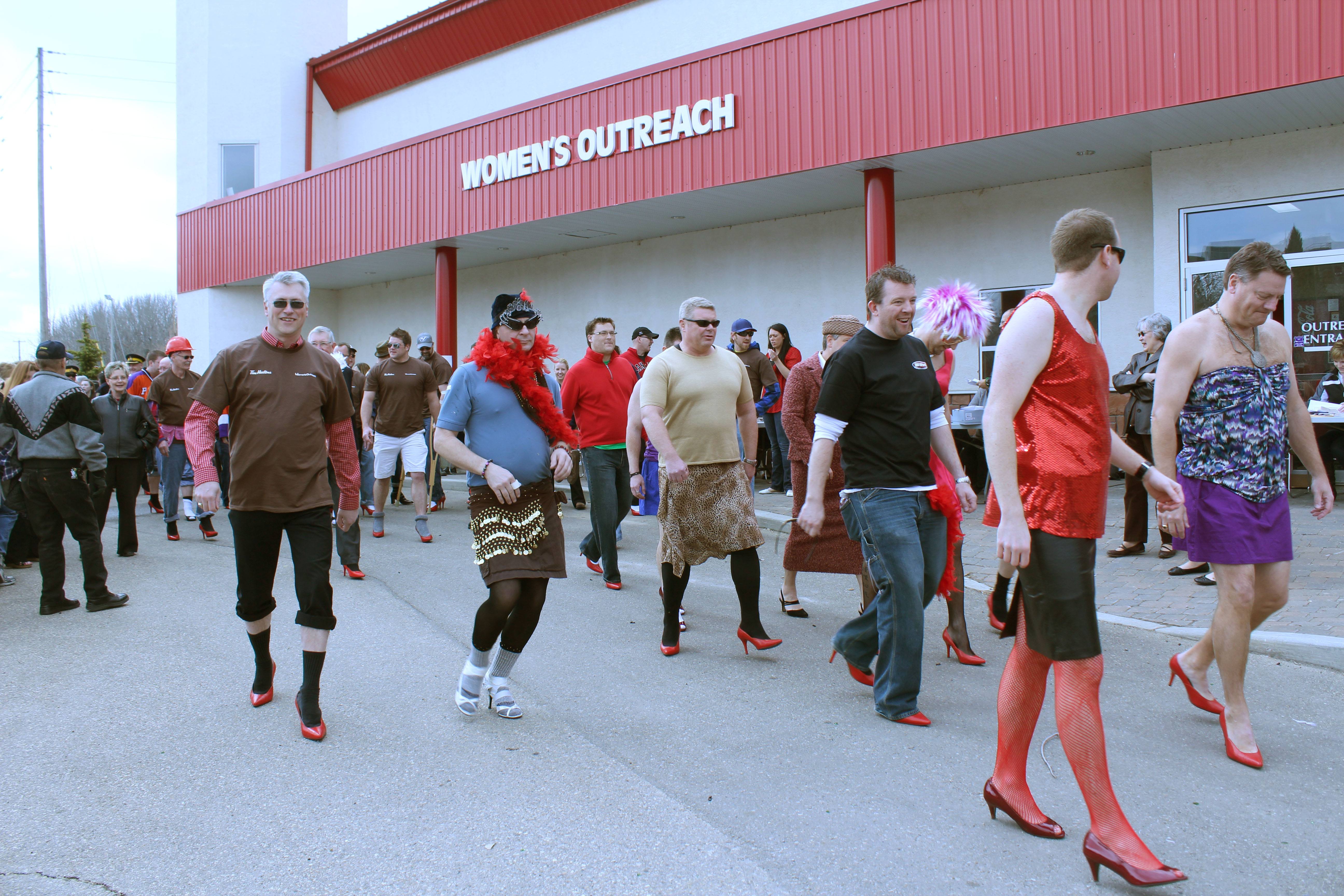 HIGH FASHION- Men from the community of Red Deer participate in the Walk a Mile in Her Shoes fundraiser Thursday afternoon. Proceeds from the event support Women's Outreach.