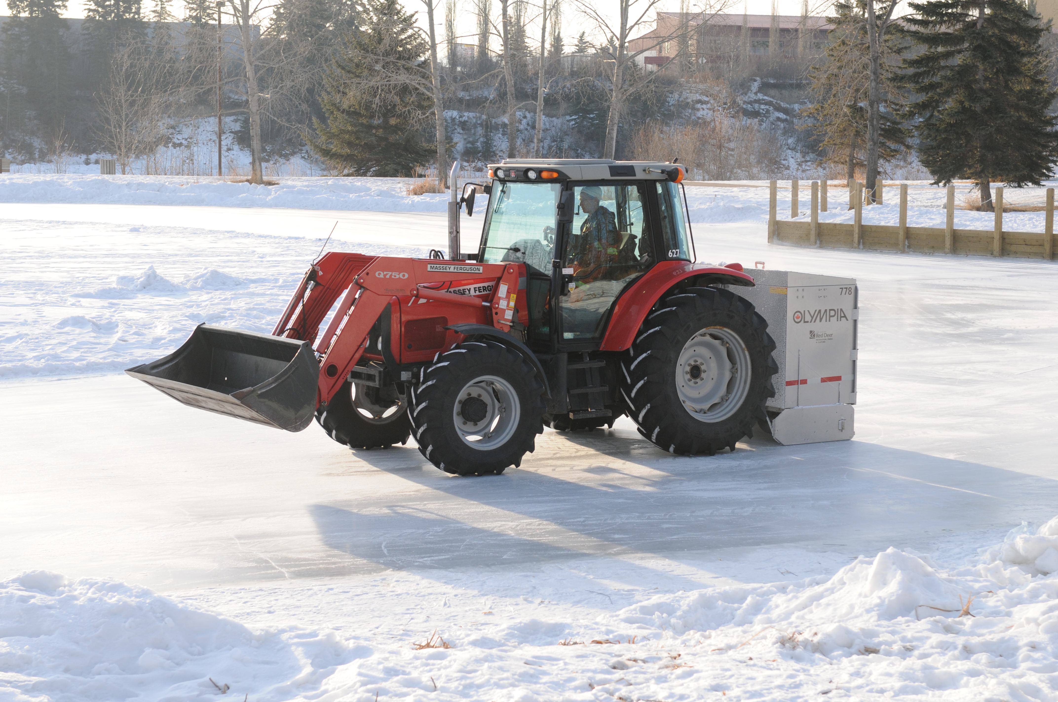 LIKE GLASS- Workers use small tractors to clear and smooth the ice down at Bower Ponds to get ready for another busy weekend of skaters.