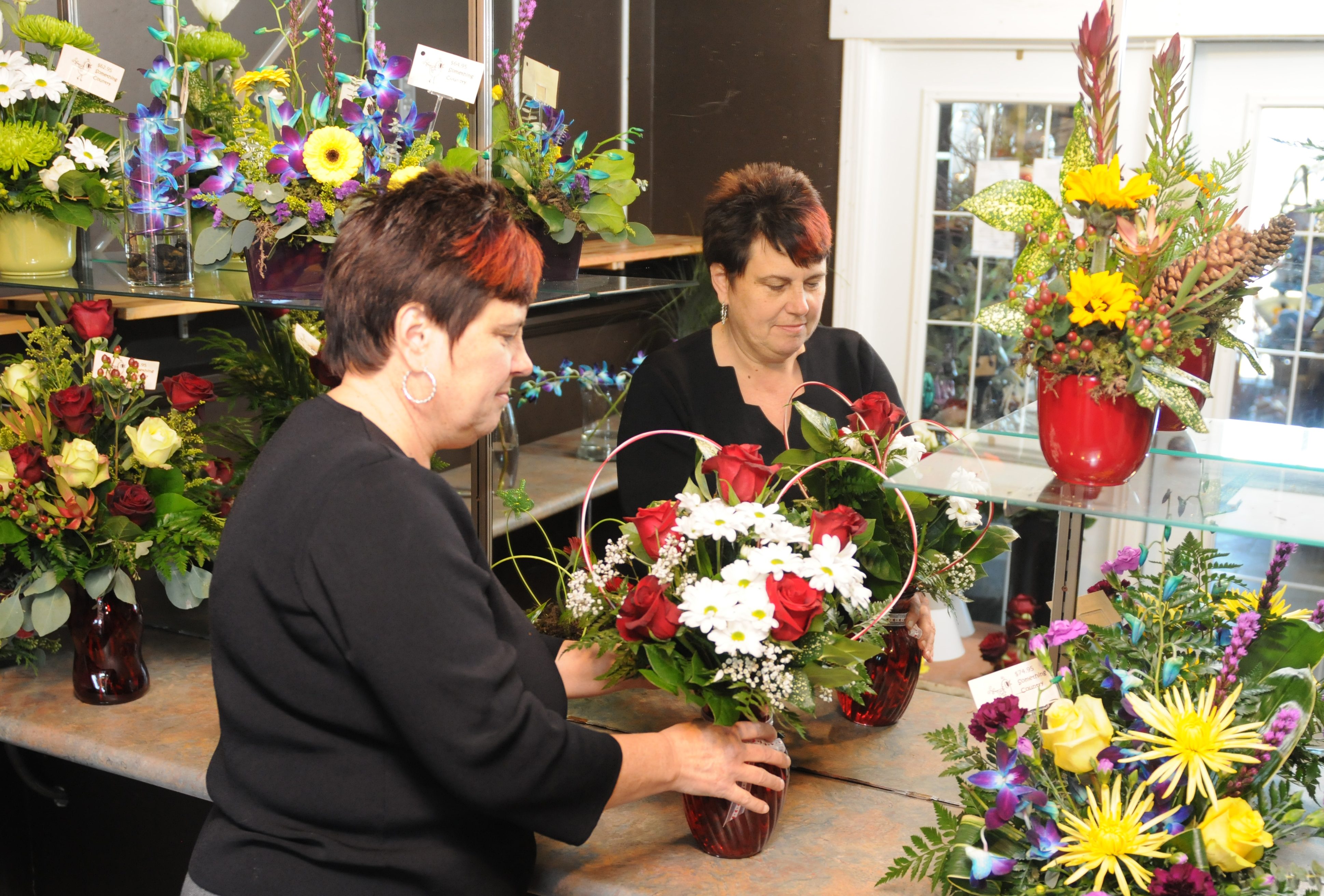 COLOURFUL DISPLAY- Designer Marina Bengivingo works on arranging flowers for a Valentine’s Day bouquet recently at Something Country Flowers & Gifts.