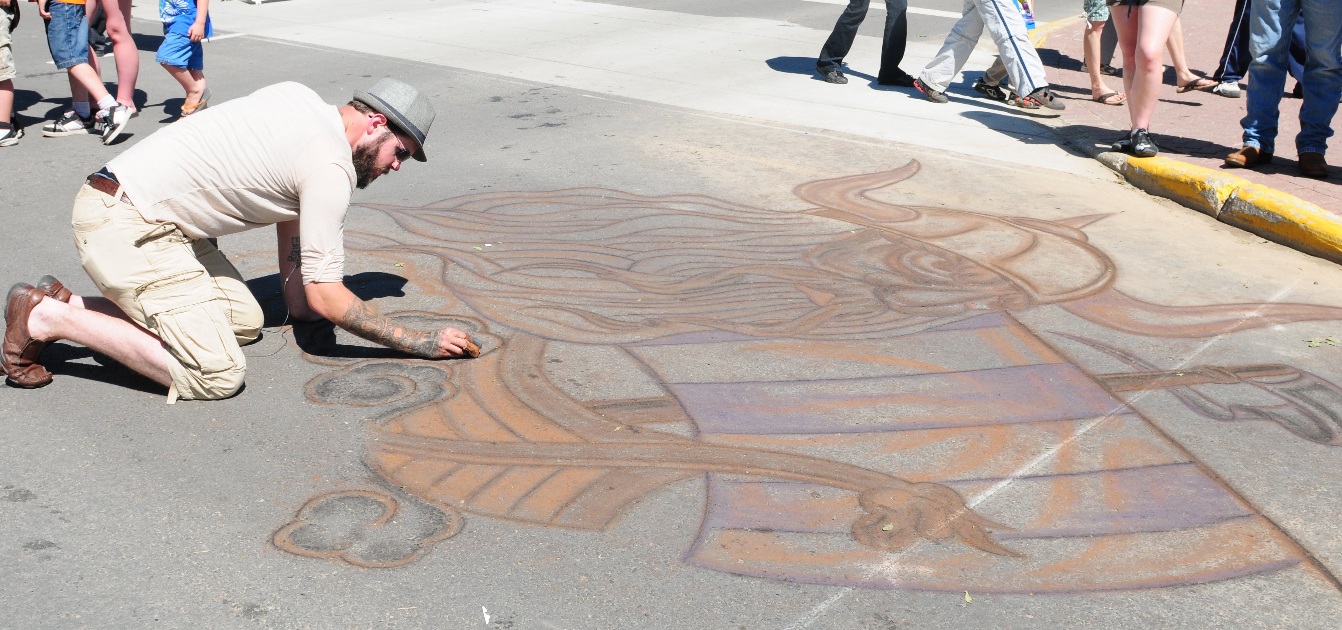 AMAZING ART- Artist Josh Christensen uses his fingers to chalk out a viking on the sidewalk during CentreFest this past weekend downtown.