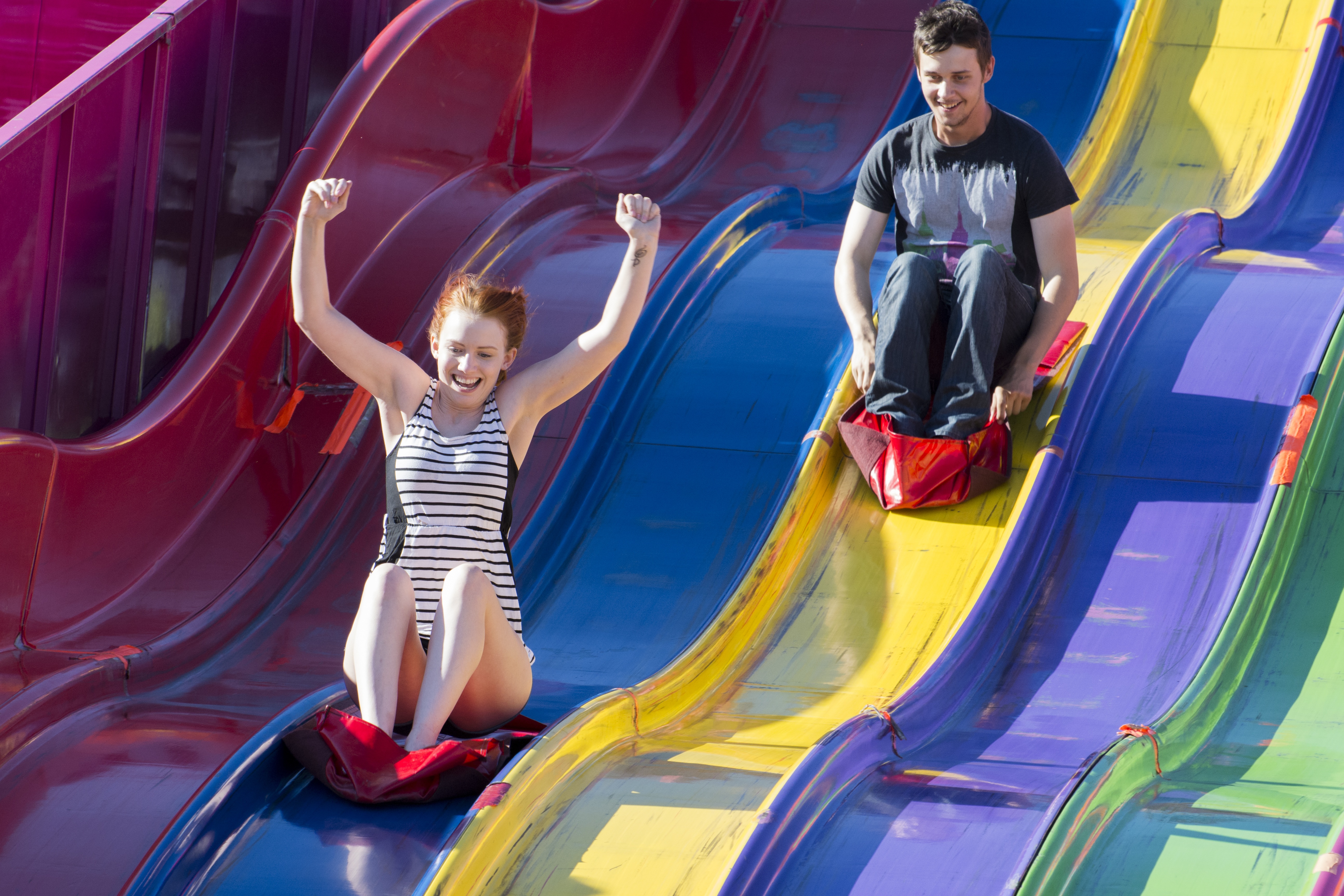 BIG RACE – Emily Holmes races ahead of Matt Bailey on one of the big slides during Westerner Days.