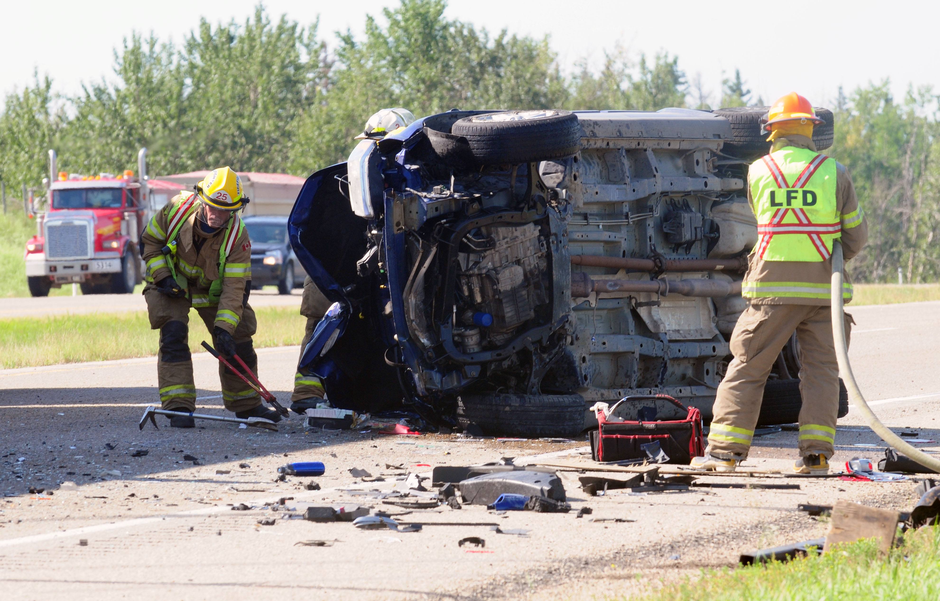 CLEANUP- Red Deer Emergency Services crews work on cleaning up on scene where two trucks collided causing one to rollover. City RCMP continue to investigate the cause.