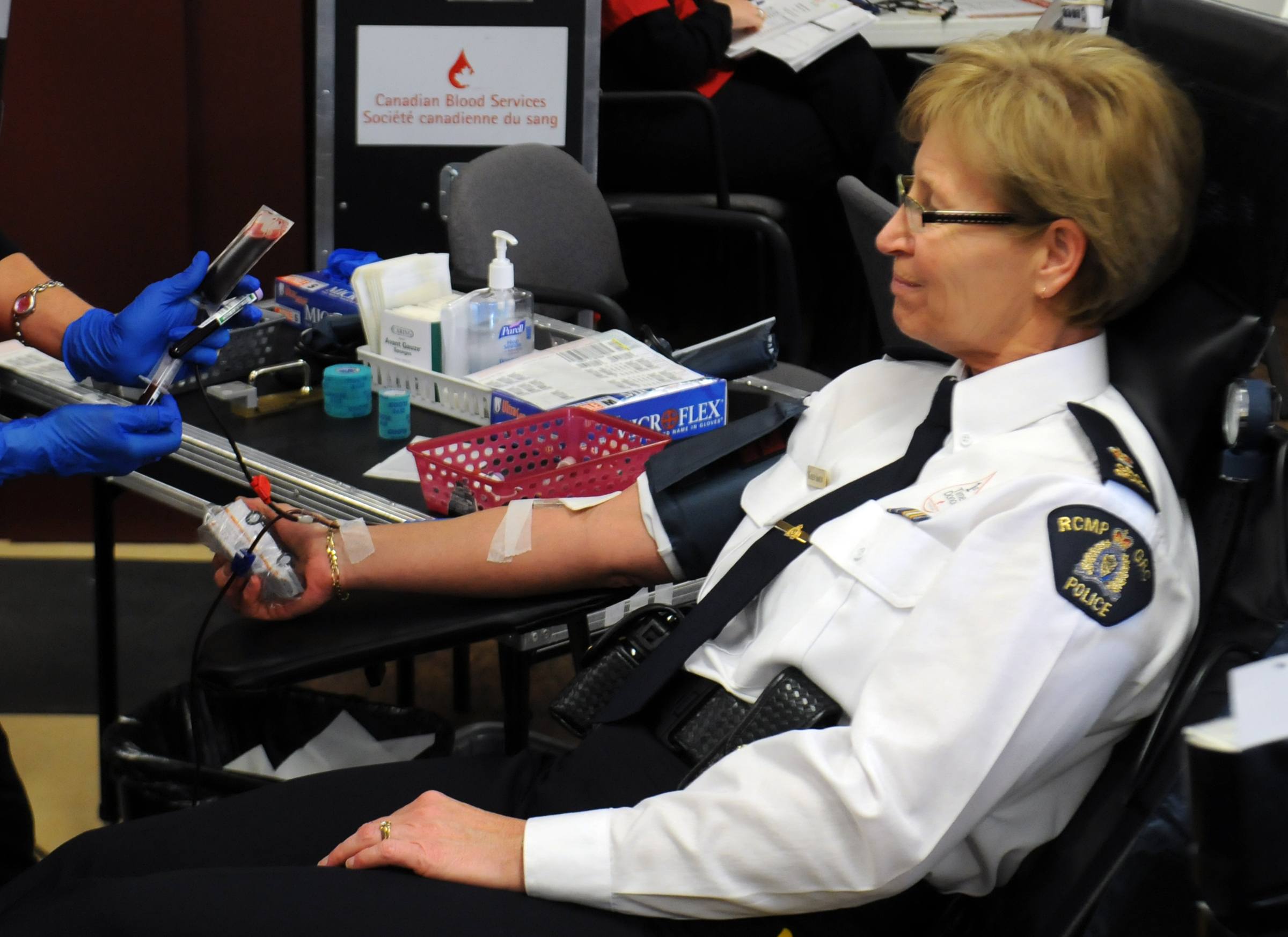 RIVALRY- Insp. Karen Simon sits patiently as she gives blood during the kick off for the Sirens for Life blood donor challenge at the Golden Circle Tuesday afternoon. The campaign runs until the end of January. To make an appointment call 1-888-2DONATE.