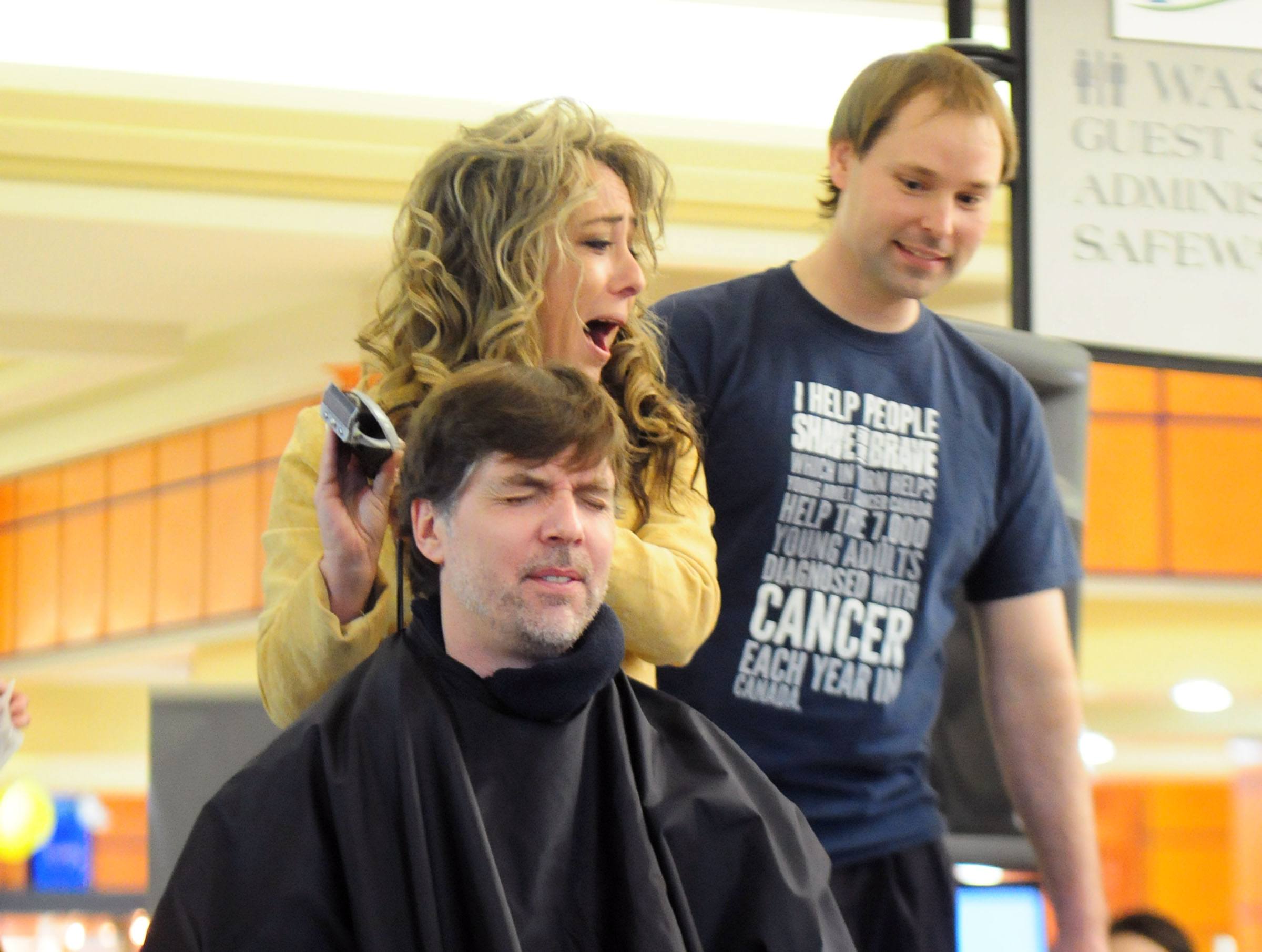 SHAVE IT- Greg Shannon shuts his eyes as Suzy Burge laughs while shaving his head for the first annual Shave for the Brave this past weekend at the Parkland Mall.