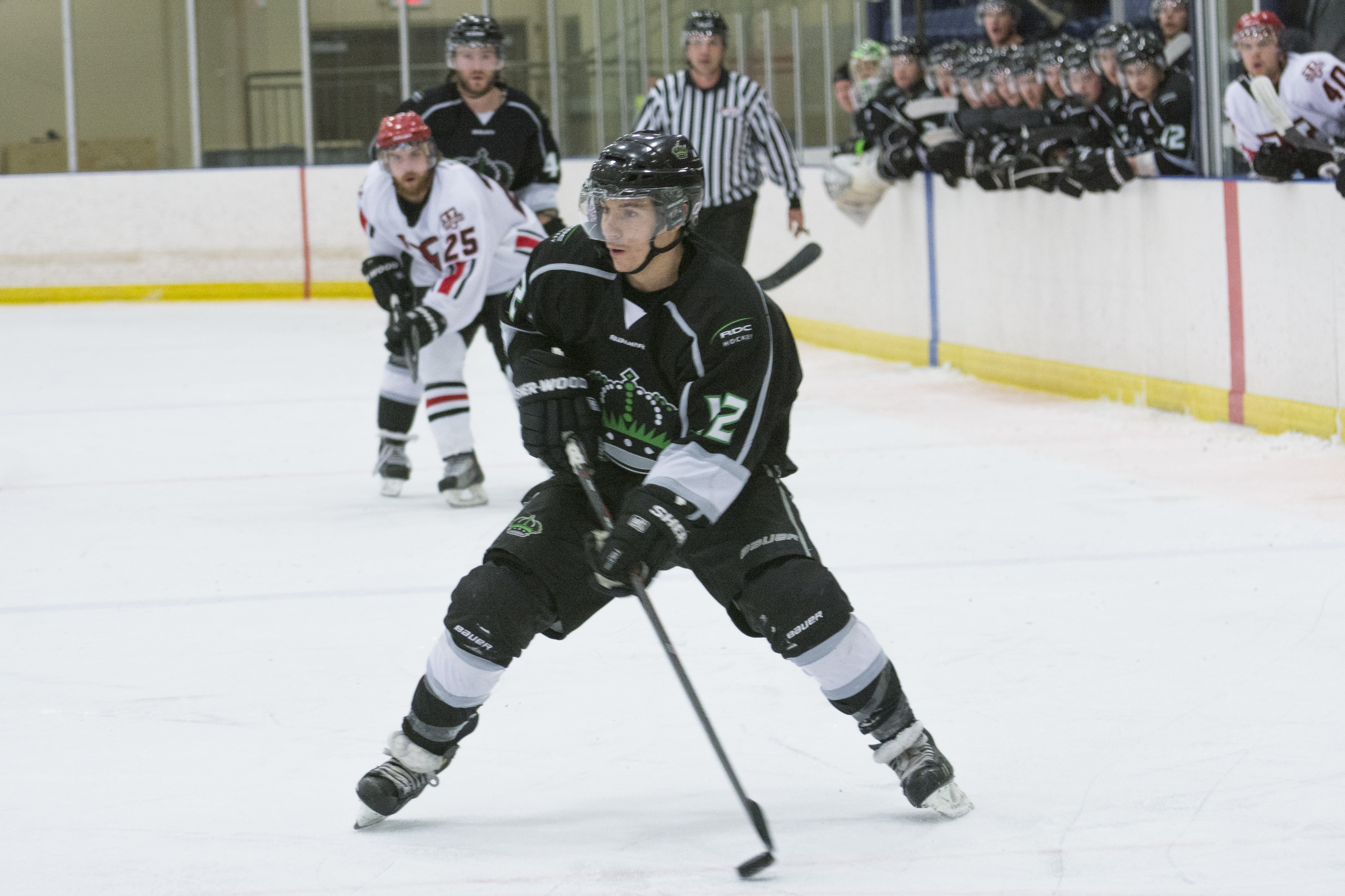 FORWARD DRIVE – Kings Centre Clay Petrie pushes the puck up the ice during a game last Saturday. The Kings were eliminated from the ACAC playoffs after losing to the Augustana Vikings.