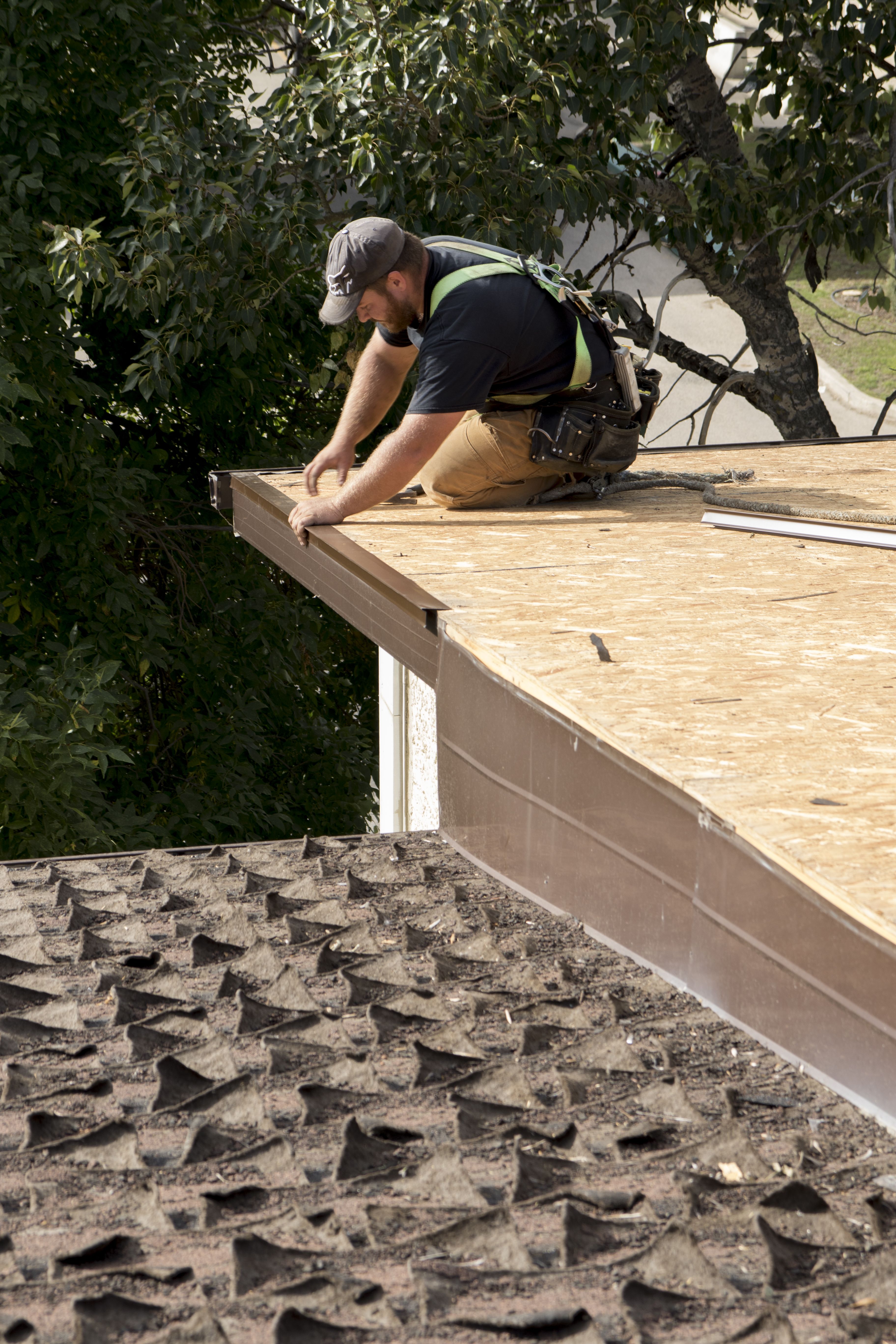 A HELPING HAND – Denis Savard worked hard on the new roof of the Loaves and Fishes Benevolent Society. The roof was leaking severely