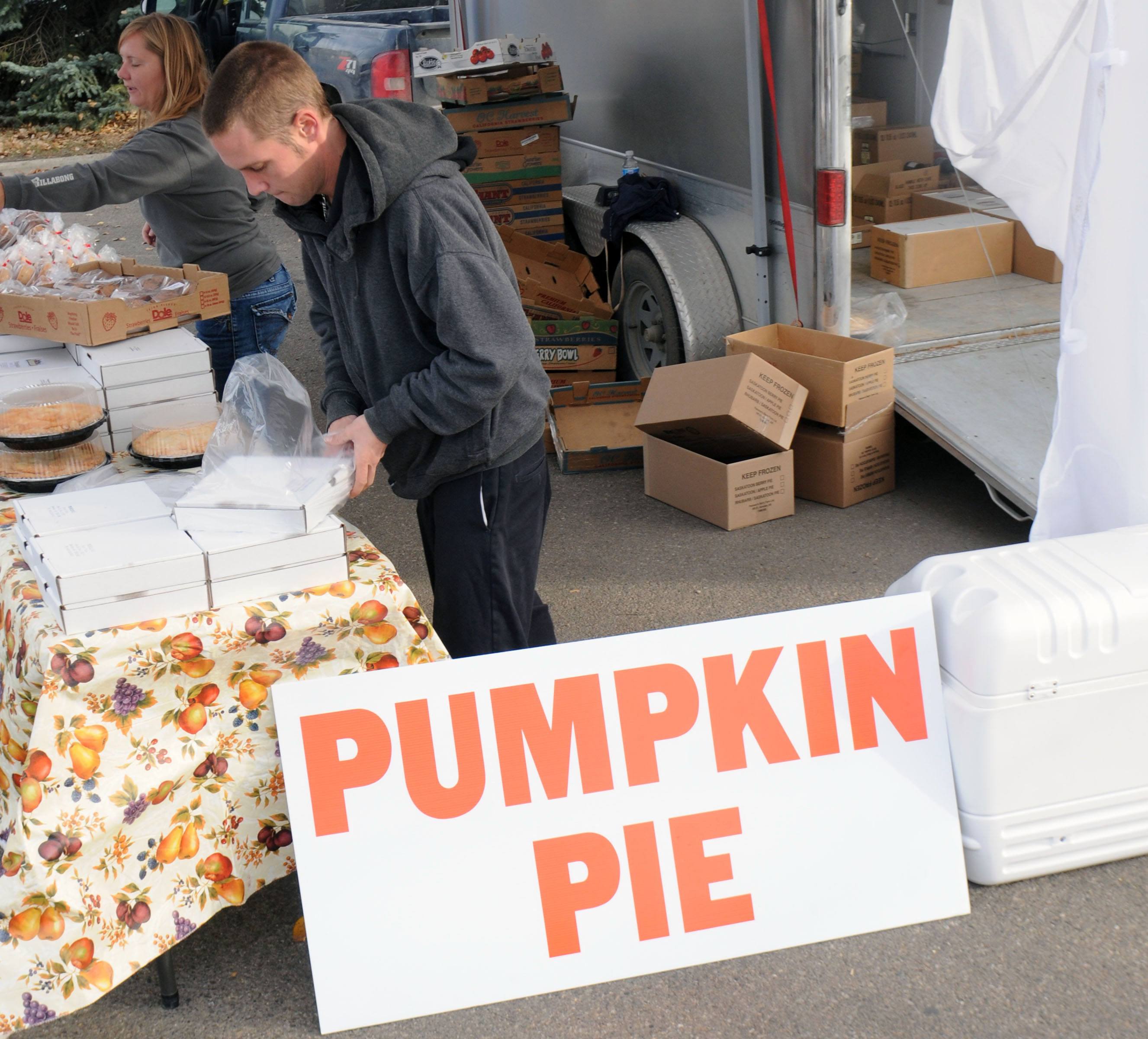 DELICIOUS PIE- Evan Mertin with Pearson's Berry Farm packs up a pie at the last Red Deer Market of the year Saturday as people scrambled to buy pies for Thanksgiving.