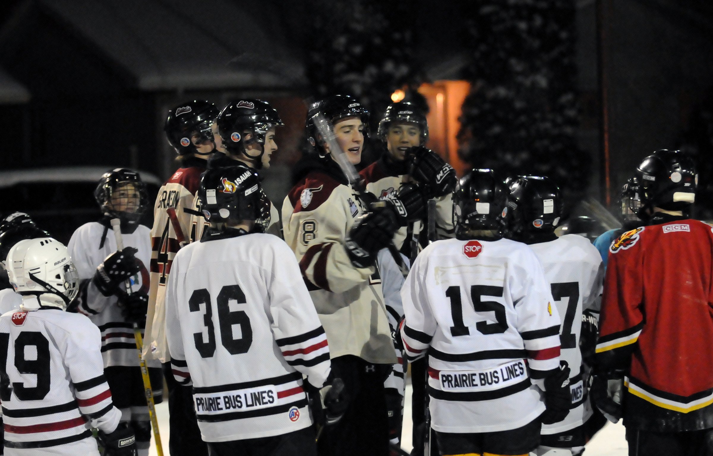 EXCITING VISIT- Young pond hockey players listen as Red Deer Rebel Brett Ferguson coaches them recently.  The Rebels visited local outdoor rinks teaching youngsters the joys of hockey and even played a few games.