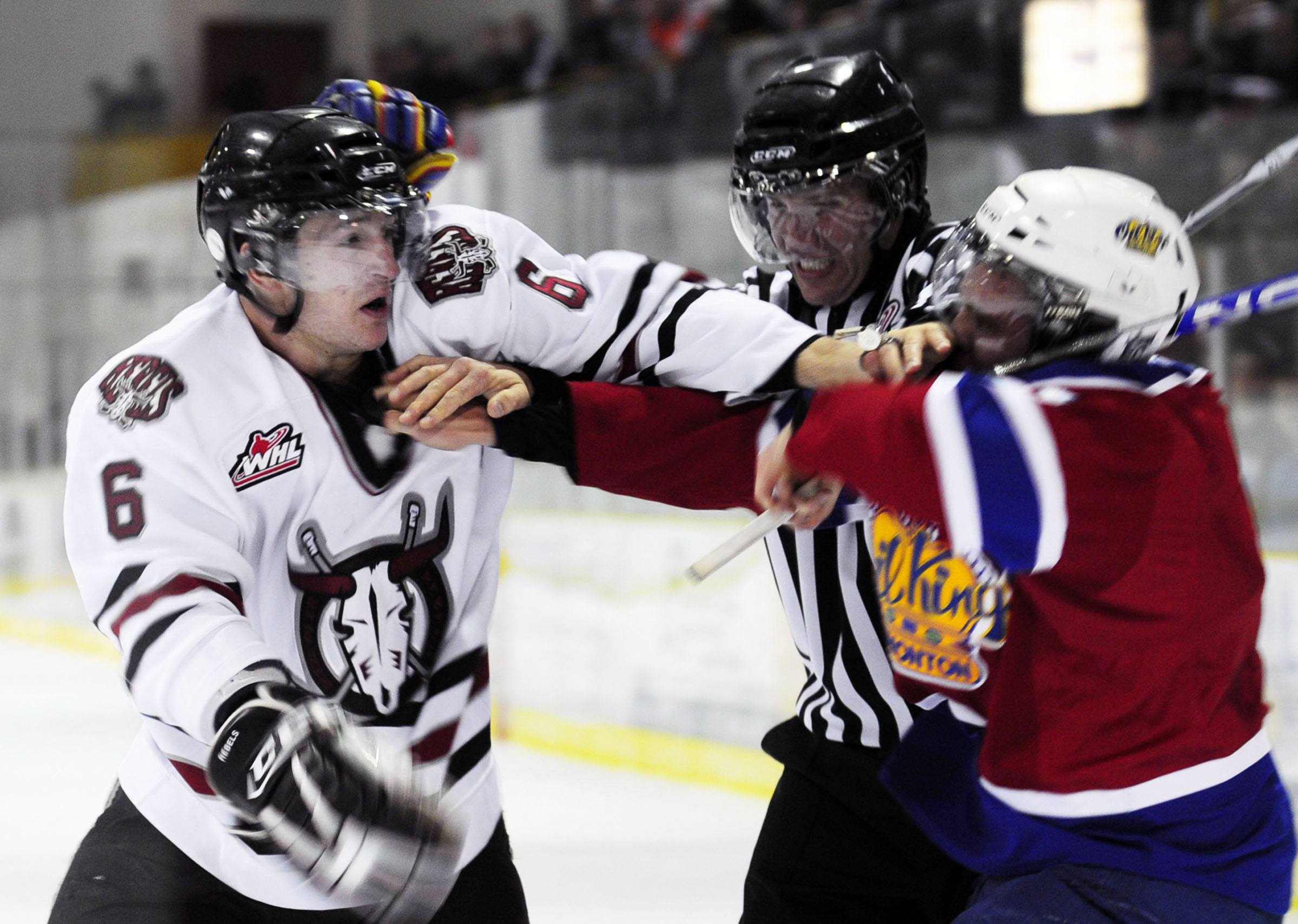 GETTING ROUGH- Red Deer Rebel Colin Archer takes on Edmonton Oil King Adrian Van De Mosselaer during WHL pre-season action.