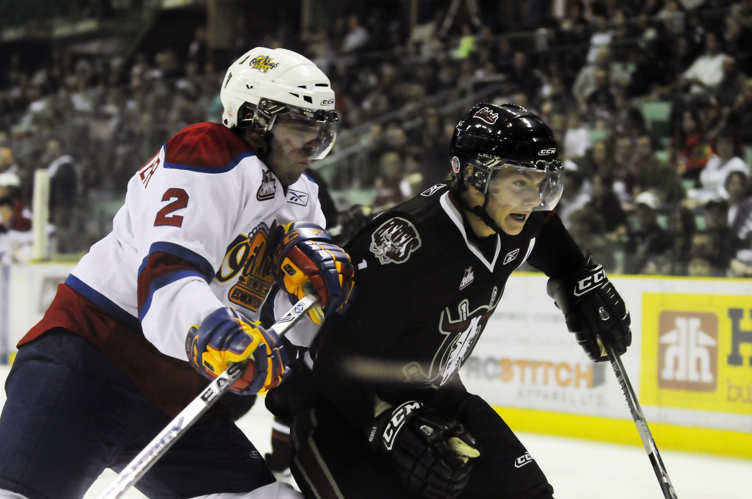 Red Deer Rebel Byron Froese and Edmonton Oil King Adrian Van de Mosselaer brace for impact during the Rebels home opener Saturday night. The Rebels won 8-1.