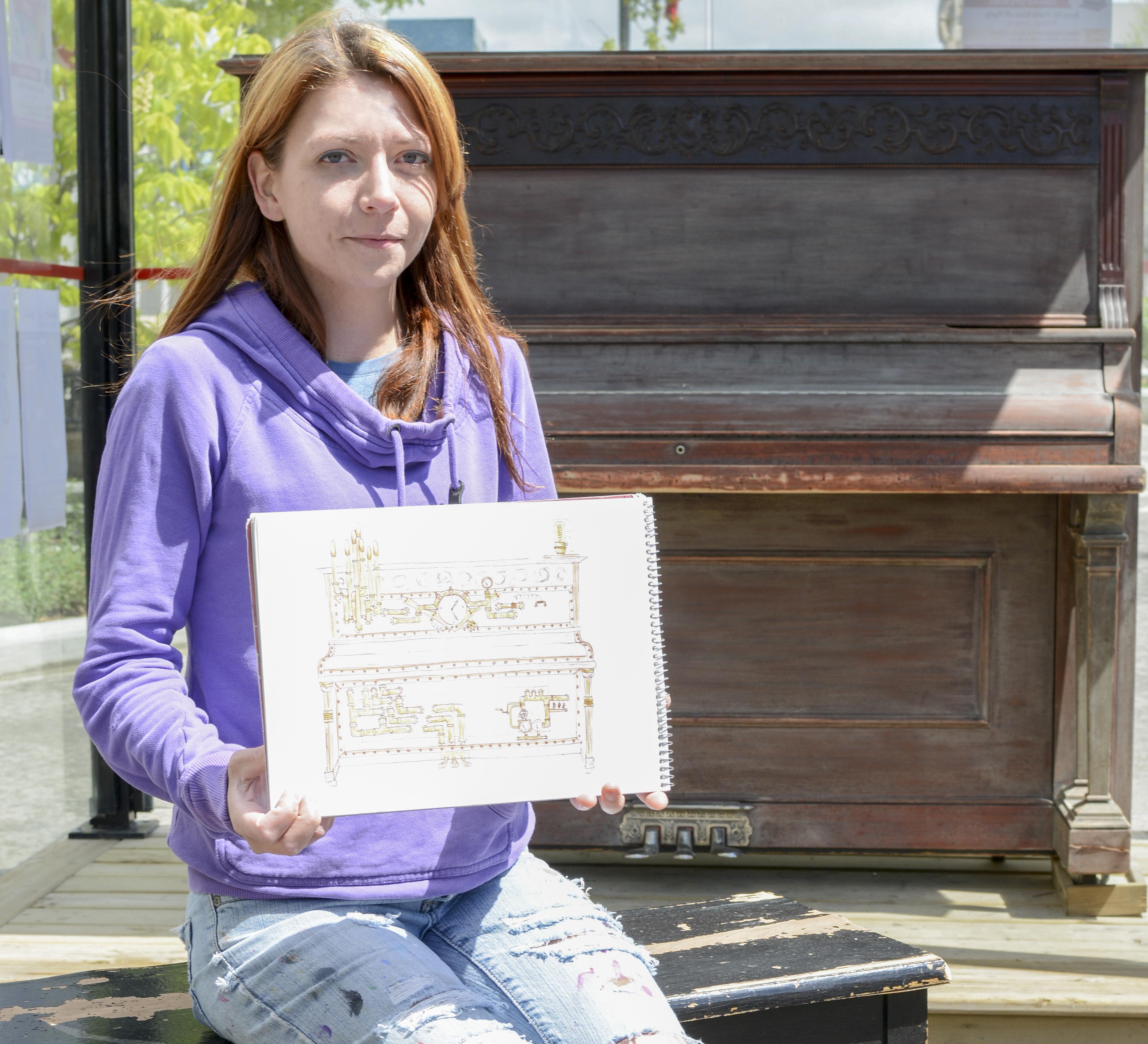 NEW DESIGN – Carmen Winter shows a drawing of the finished product for the Ross Street Patio piano.