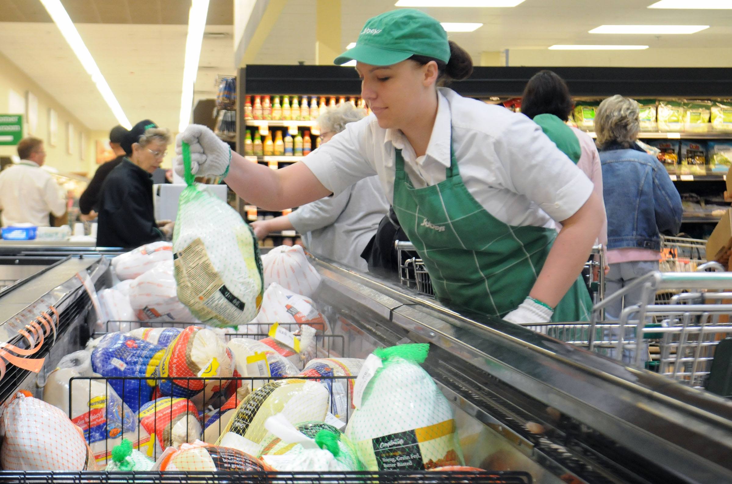 STOCKING UP- Melissa Atkison puts out more turkeys at Sobeys south in Red Deer as last minute Thanksgiving shoppers scramble to the shelves.