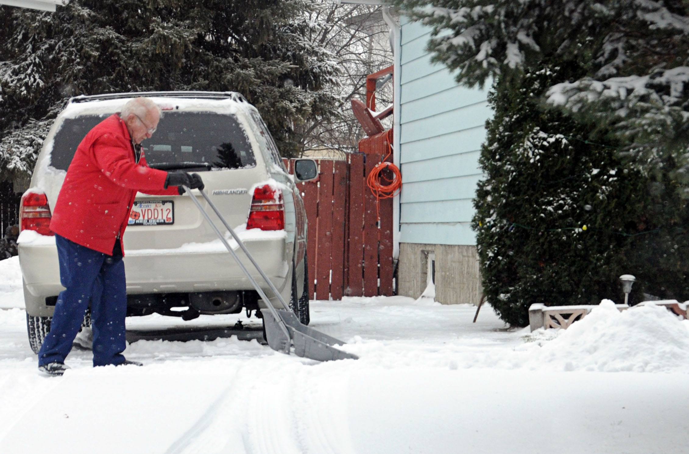 WELCOME WINTER – A local shovels the snow from his driveway after the first real snowfall of the season. Central Alberta was hit with the blast of winter late Monday night. Snow is expected to continue throughout the week.