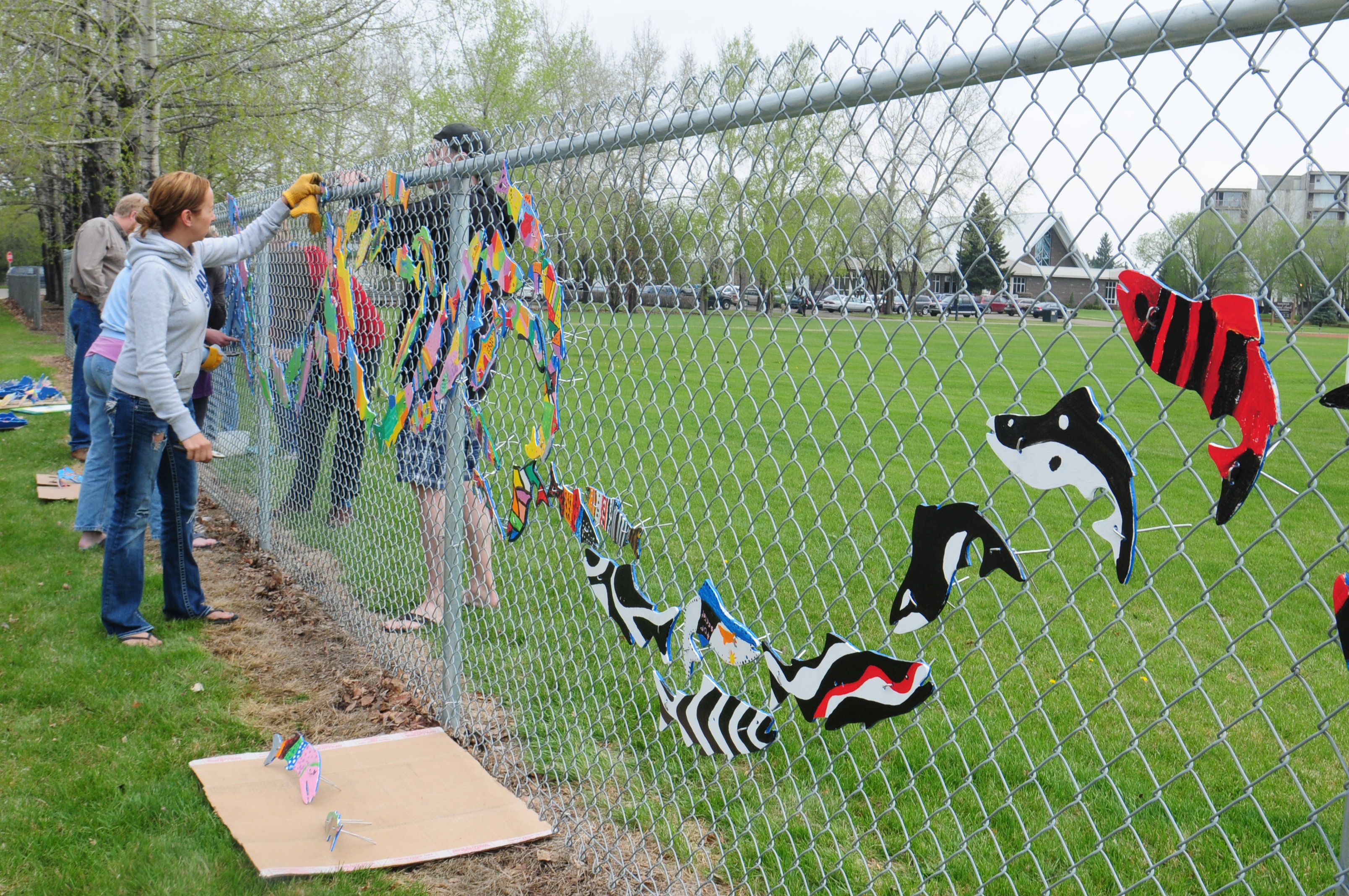 COLOURFUL- Parents of students at G.W. Smith School in Red Deer hung up their childrens colourful school of fish on the fence last week during the Stream of Dreams program where students learned about the importance of water.