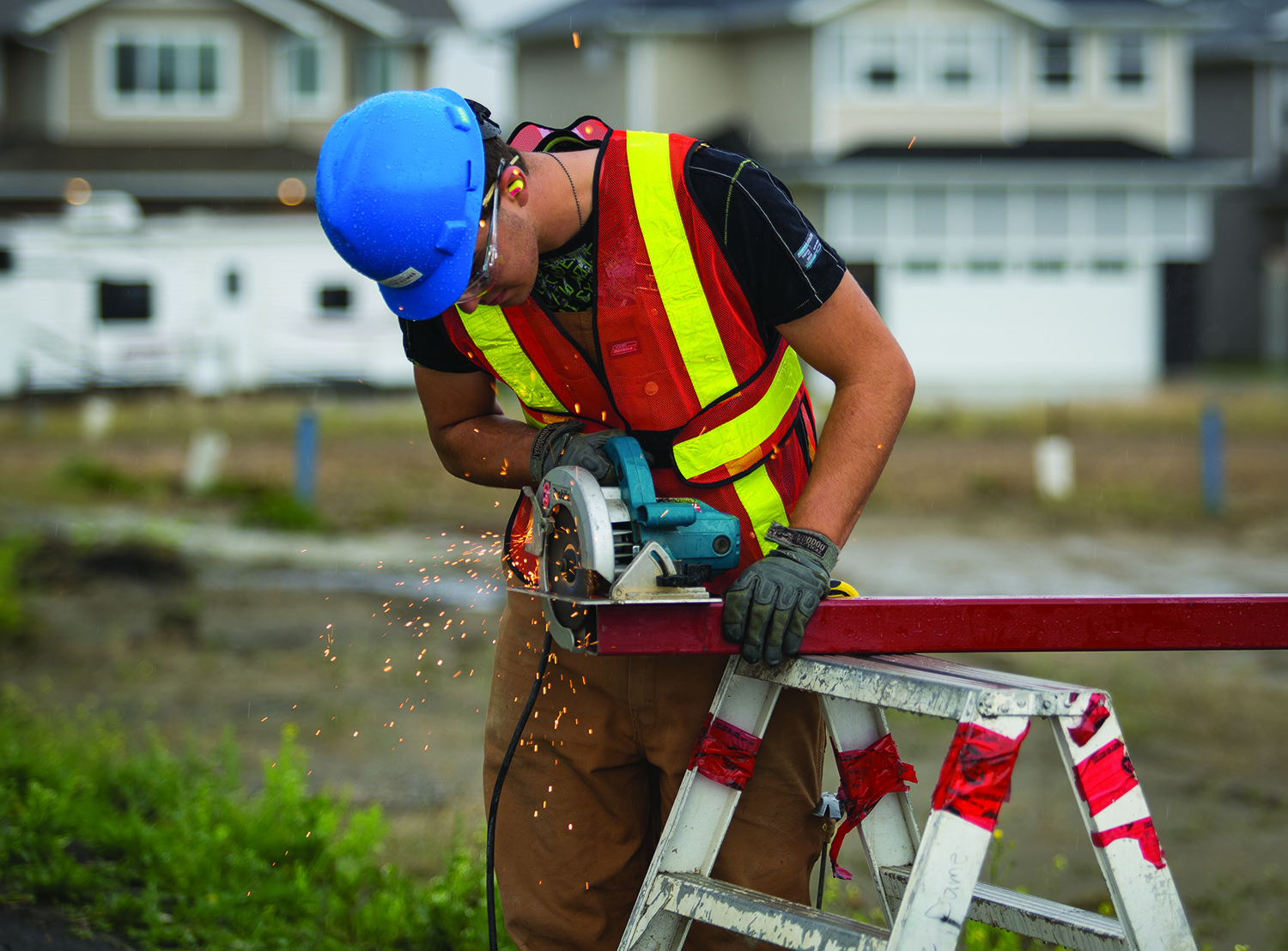 WORKING - A student from École Secondaire Notre Dame High School worked on cutting a piece of metal on the job site as part of the Building Opportunities program in Red Deer on Tuesday