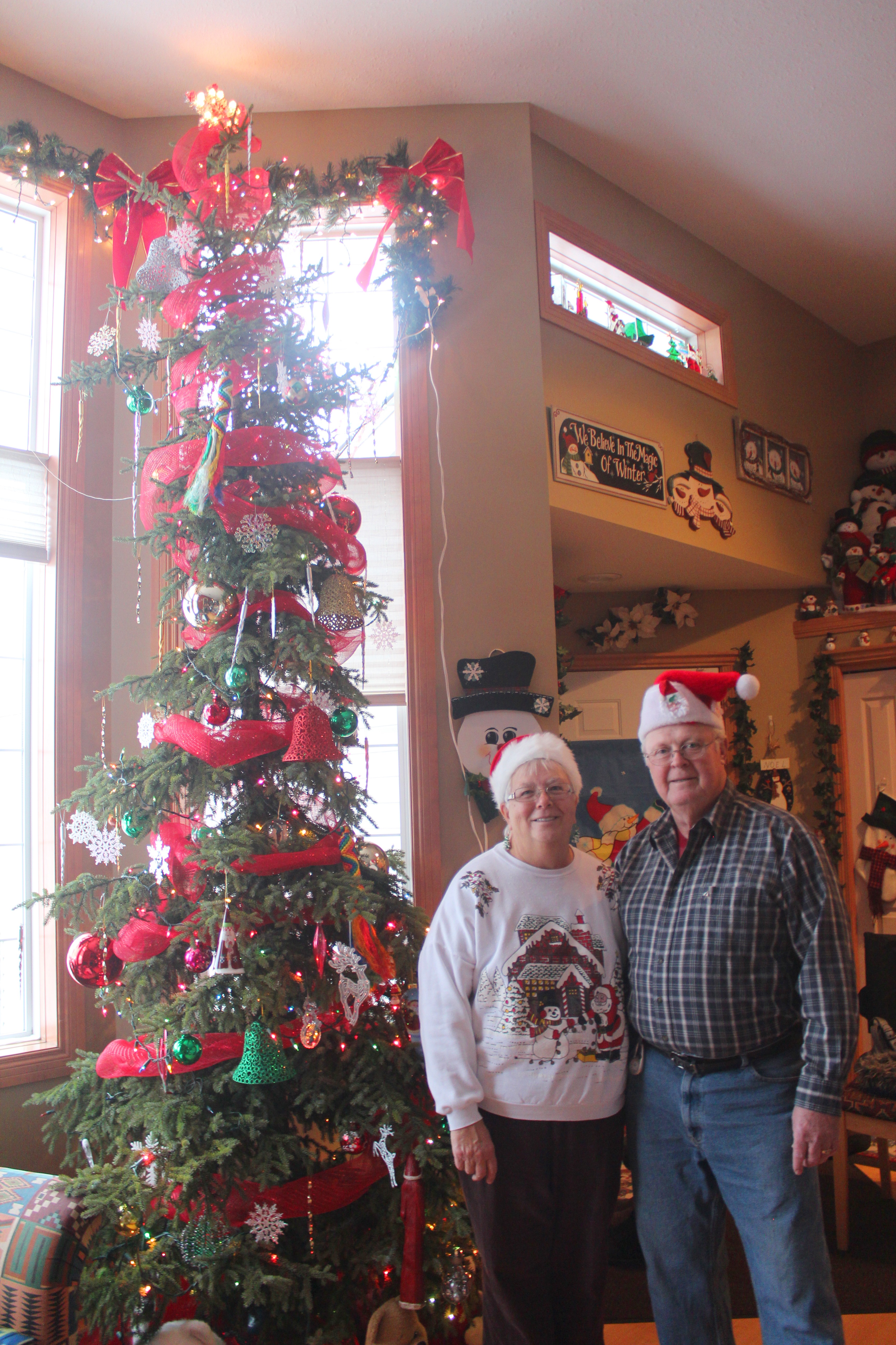 FESTIVE – Gayle and Cliff Benedictson stand beside their 12-ft. Christmas tree in their Lacombe home