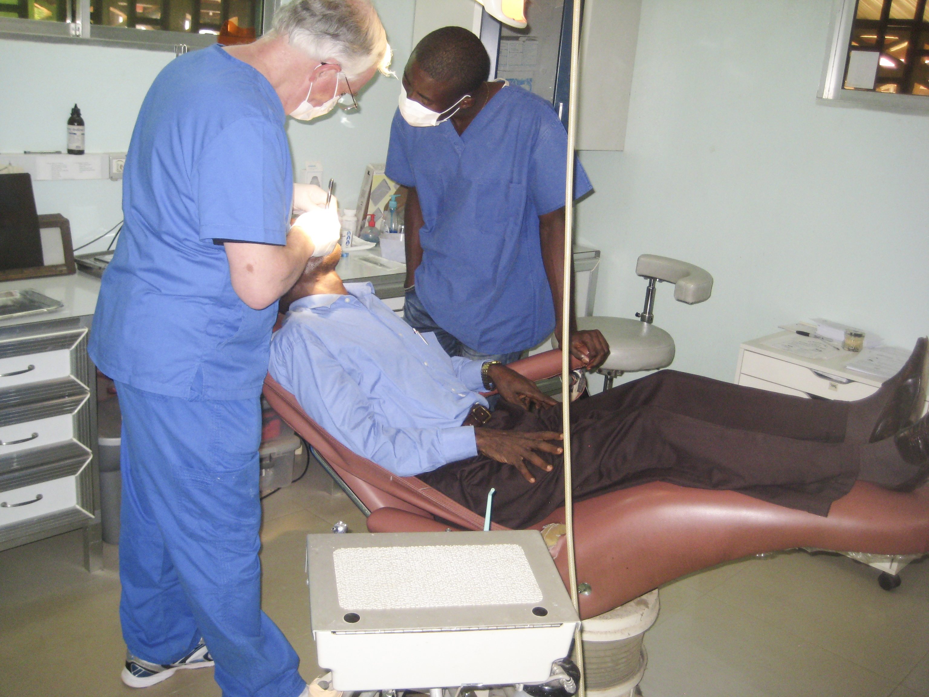 PROVIDING A NEED – Dr. Bill Hill works on a patient with the aid of his dental assistant