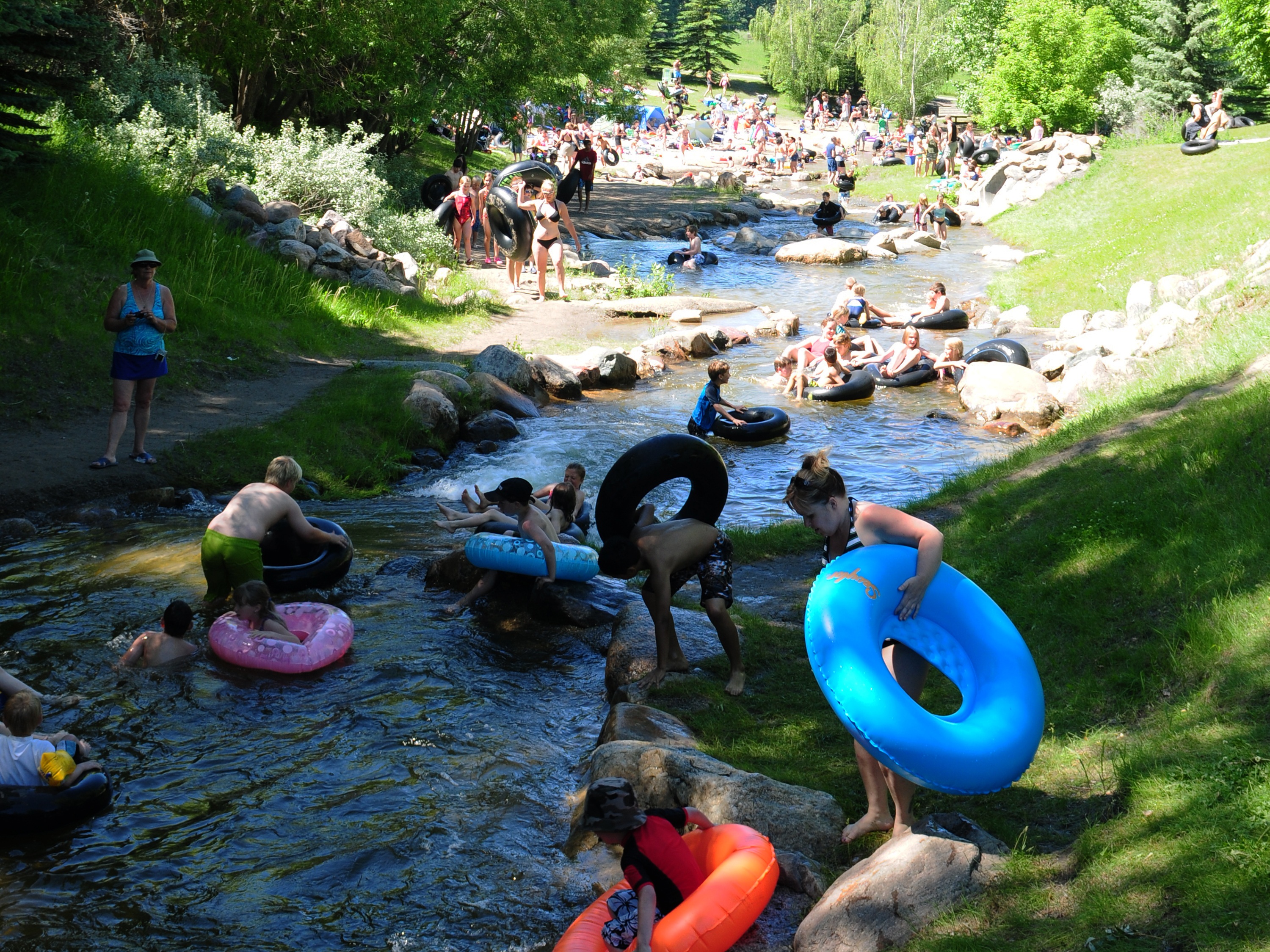 COOLING DOWN- Many Red Deerians made their way to Discovery Canyon this past week to enjoy a day of relaxation and fun as children went sliding down the waterfall on tubes.