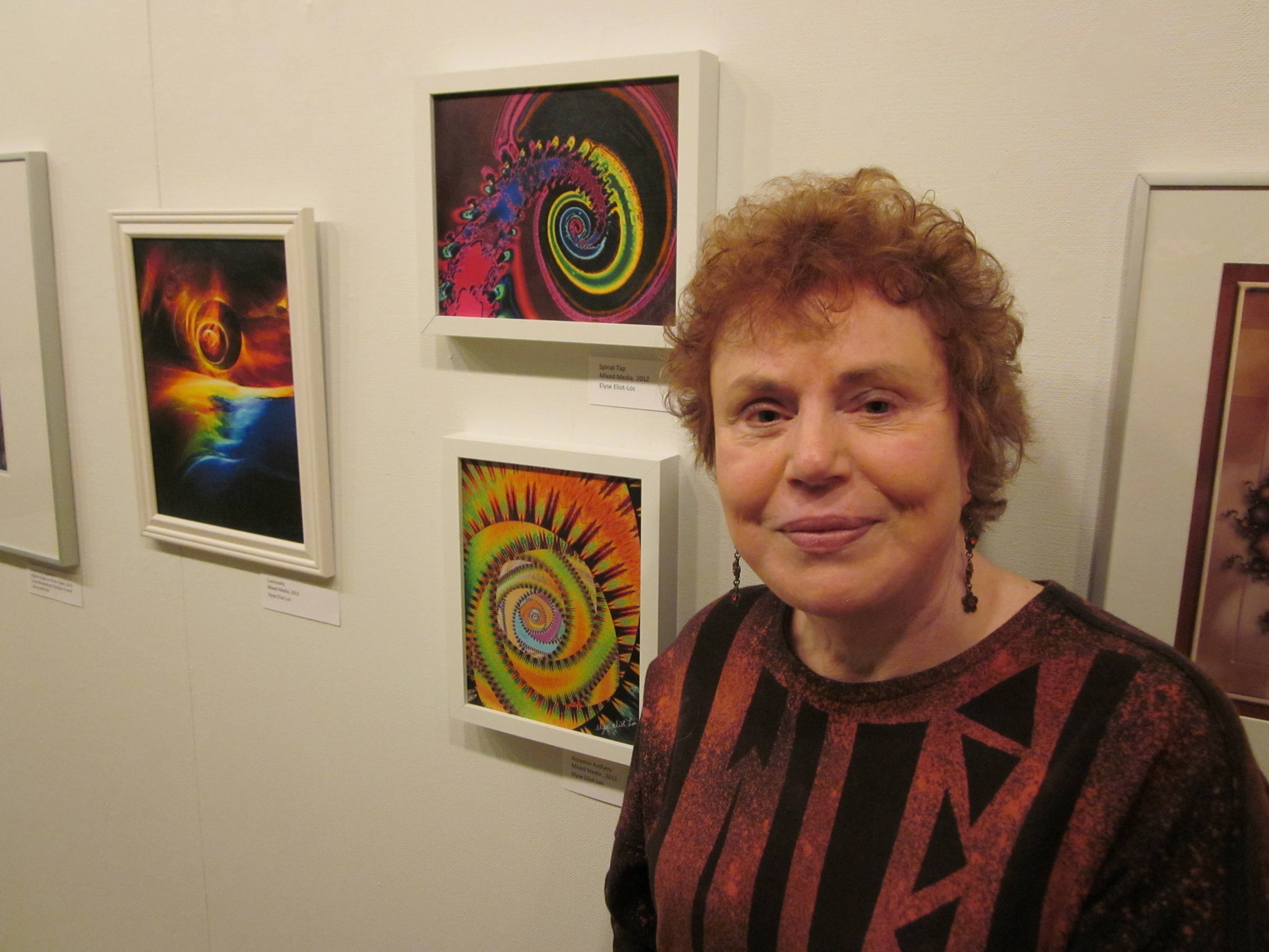 EXPLORING- Local artist Elyse Eliot-Los poses beside some samples from her latest show Fractals Infinitum at the Red Deer Public Library. She teamed up with Calgary artist Janice Johnson for the exhibit which runs until April 29.