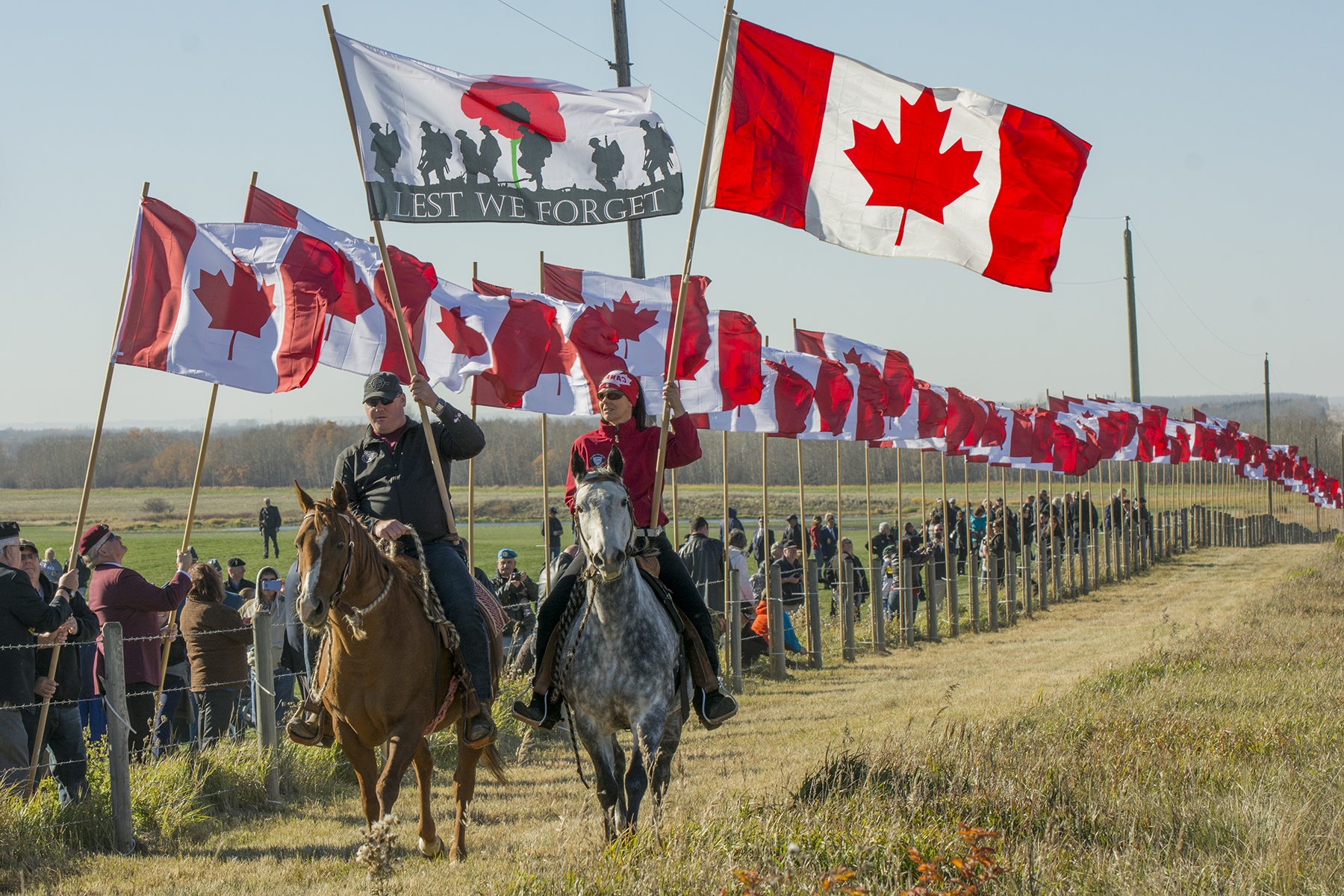 HONOUR - Last October saw Central Albertans gather outside Sylvan Lake for the second annual Veterans Voices of Canada Flags of Remembrance ceremony. Ryan Doell rides his horse Champagne next to Rebecca Santana and her horse Mable during the raising of the flags.