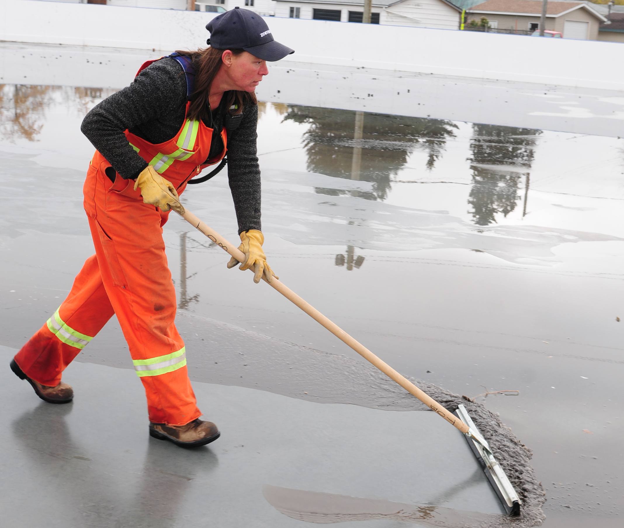 NEW ICE- Karen Saunders works on making ice in an outdoor rink recently as they prepare for the upcoming pond hockey season.