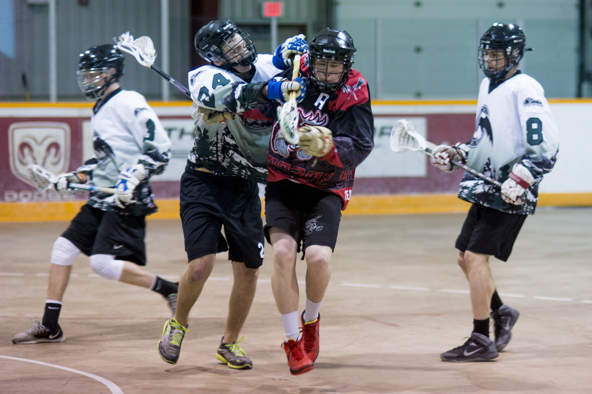 UNDEFEATED – Blayne Friesen of the Red Deer Rampage takes a hard hit in the midst of a sea of Okotoks Marauders this past Sunday during a game at the Kinex Arena.