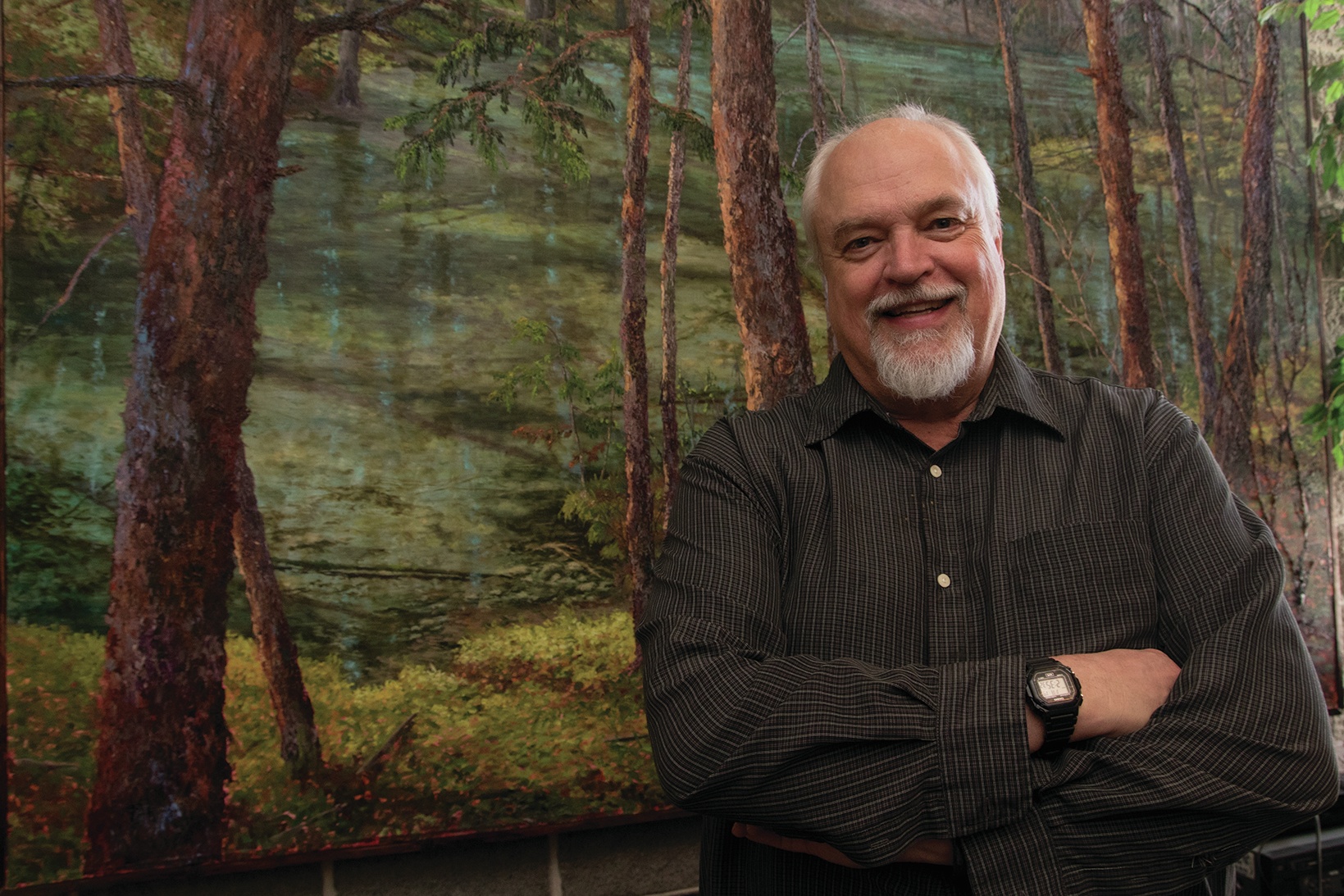 ACCOMPLISHED - Local artist Larry Reese stands with one of his many paintings that are part of his collection. Reese has explores canvas