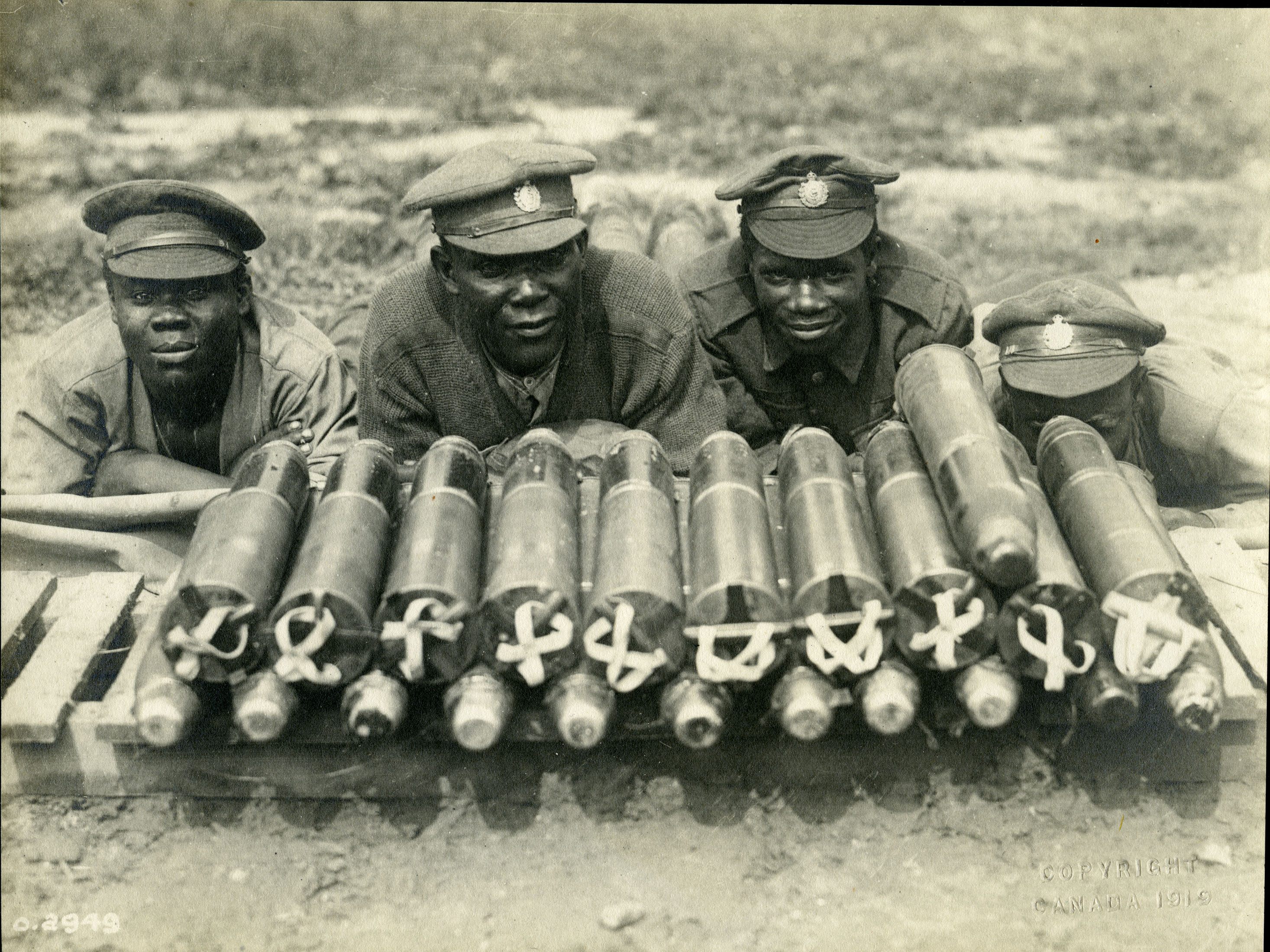 HISTORIC - Canadian soldiers with a pile of artillery shells on the front in Northern France