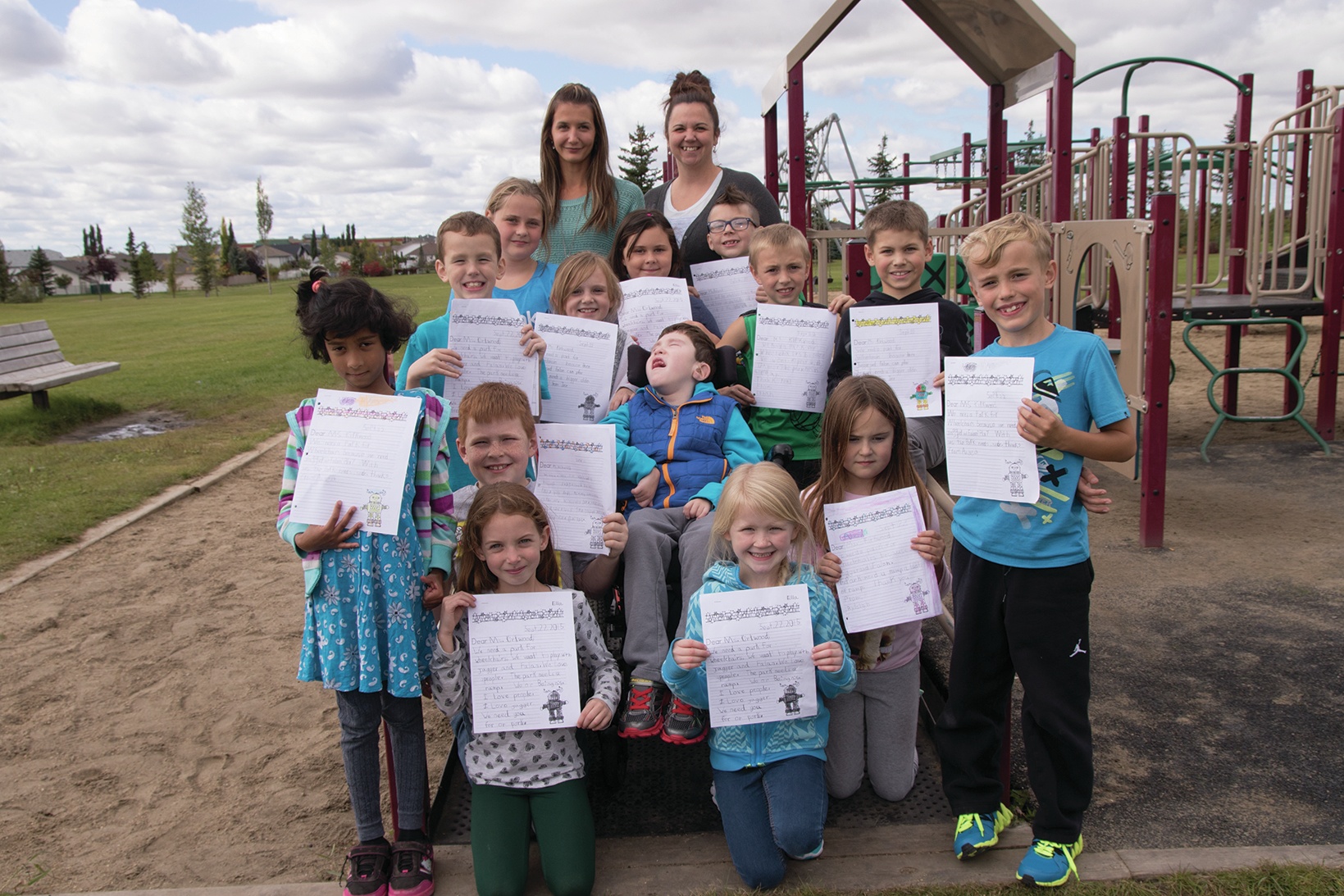 COMMUNITY BUILDING - Students of Mattie McCullough School stand with their former teacher