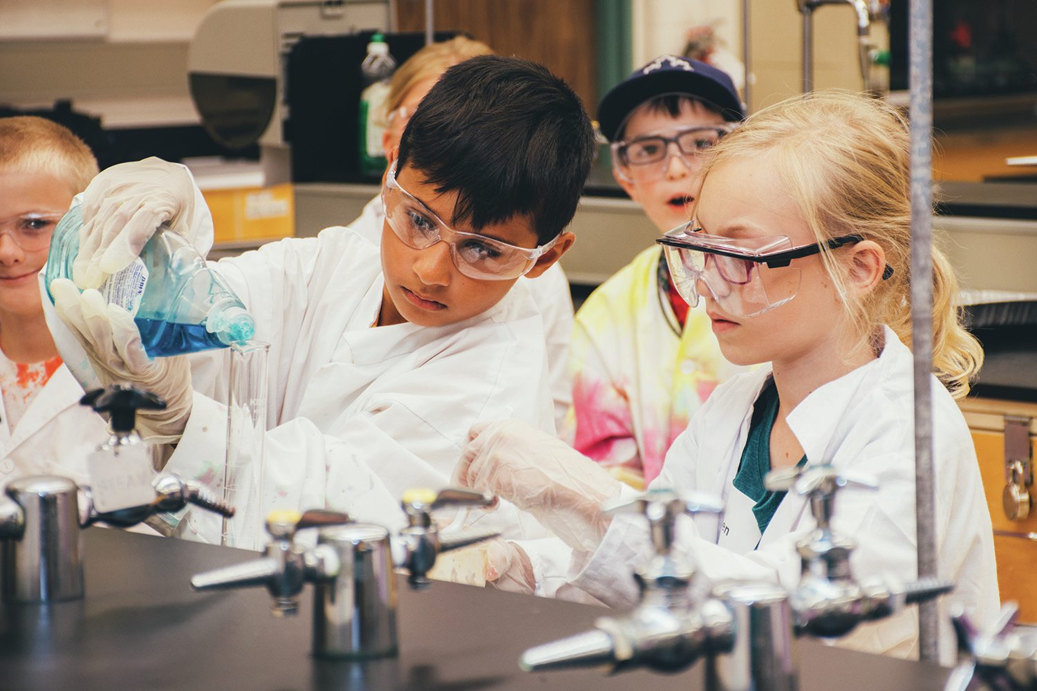 CONCENTRATION - Campers watch carefully as they measure out ingredients for their science experiment at Red Deer College’s Summer Camp program earlier this week.